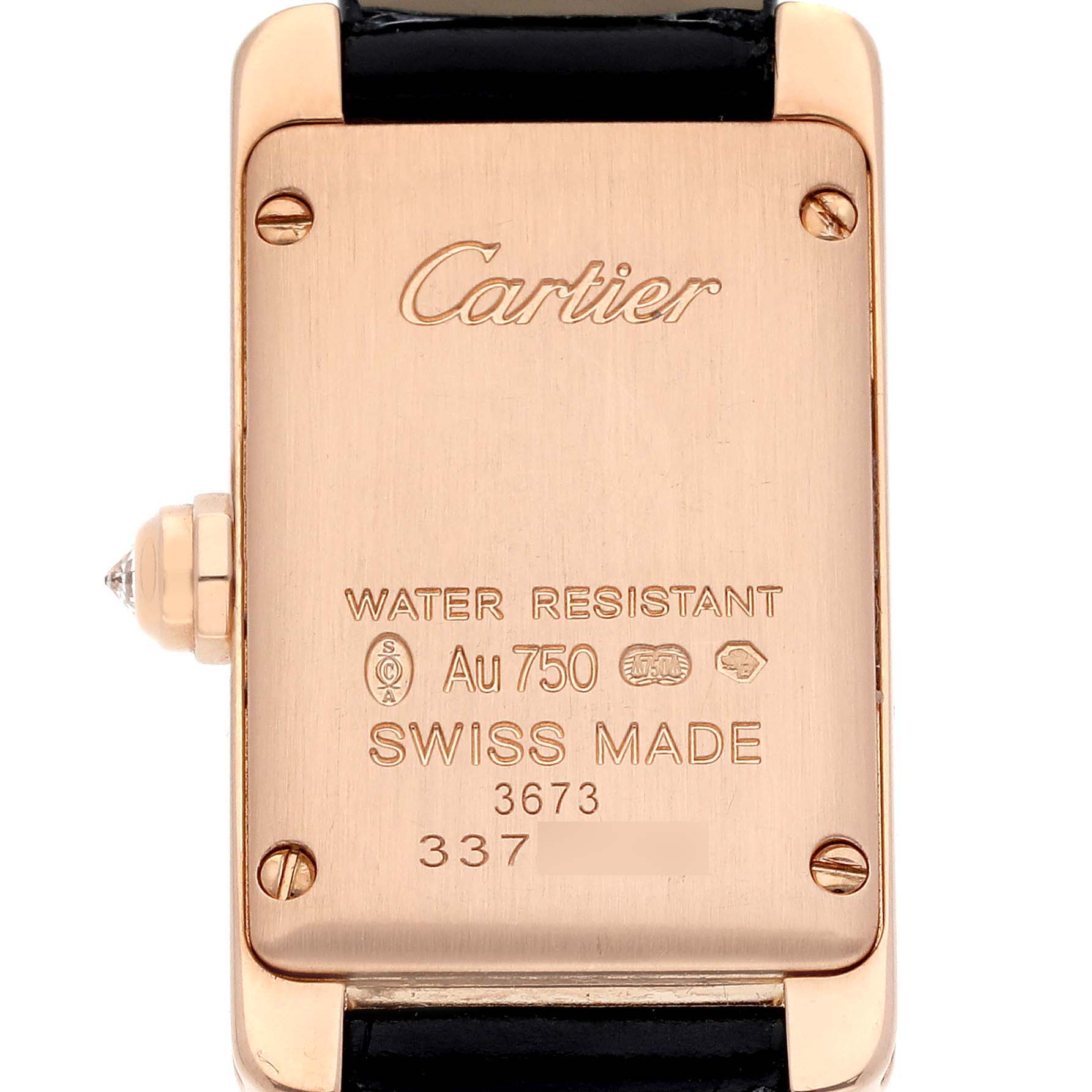 The image shows the back of the Cartier Tank Américaine watch, displaying engravings and part of the strap.