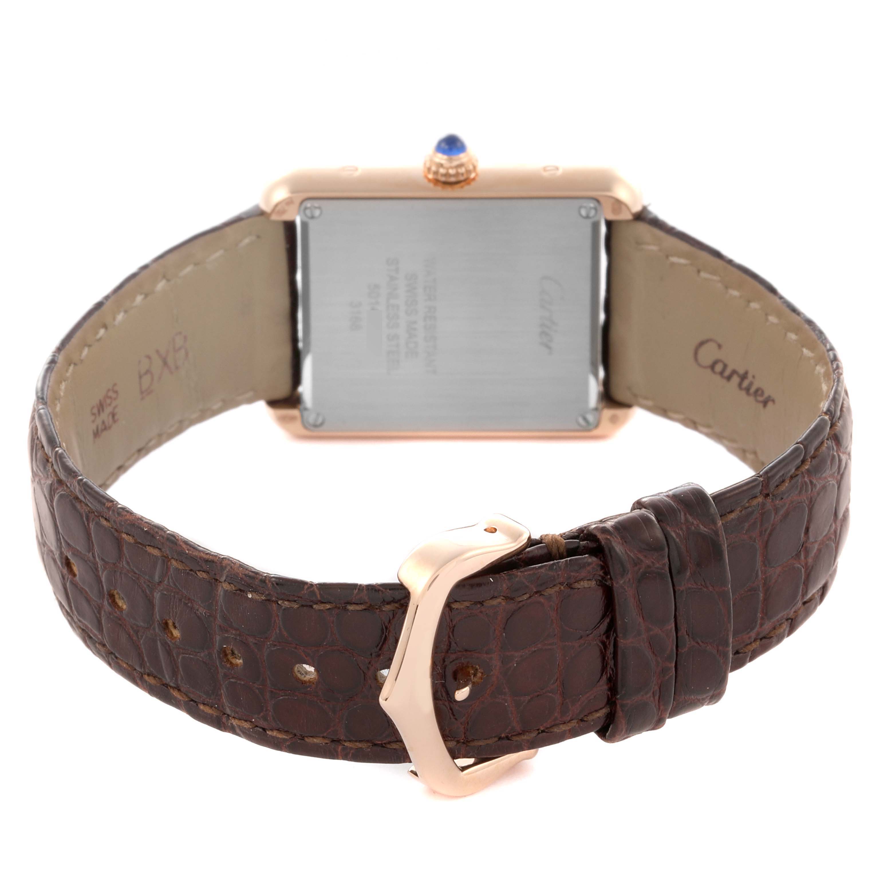 The Cartier Tank Solo W5200024 Women's Steel and Gold (two tone) Silver Dial W5200024 Women's Steel and Gold (two tone) Silver Dial watch is shown from the back, displaying the case back, crown, and brown leather strap with a buckle.