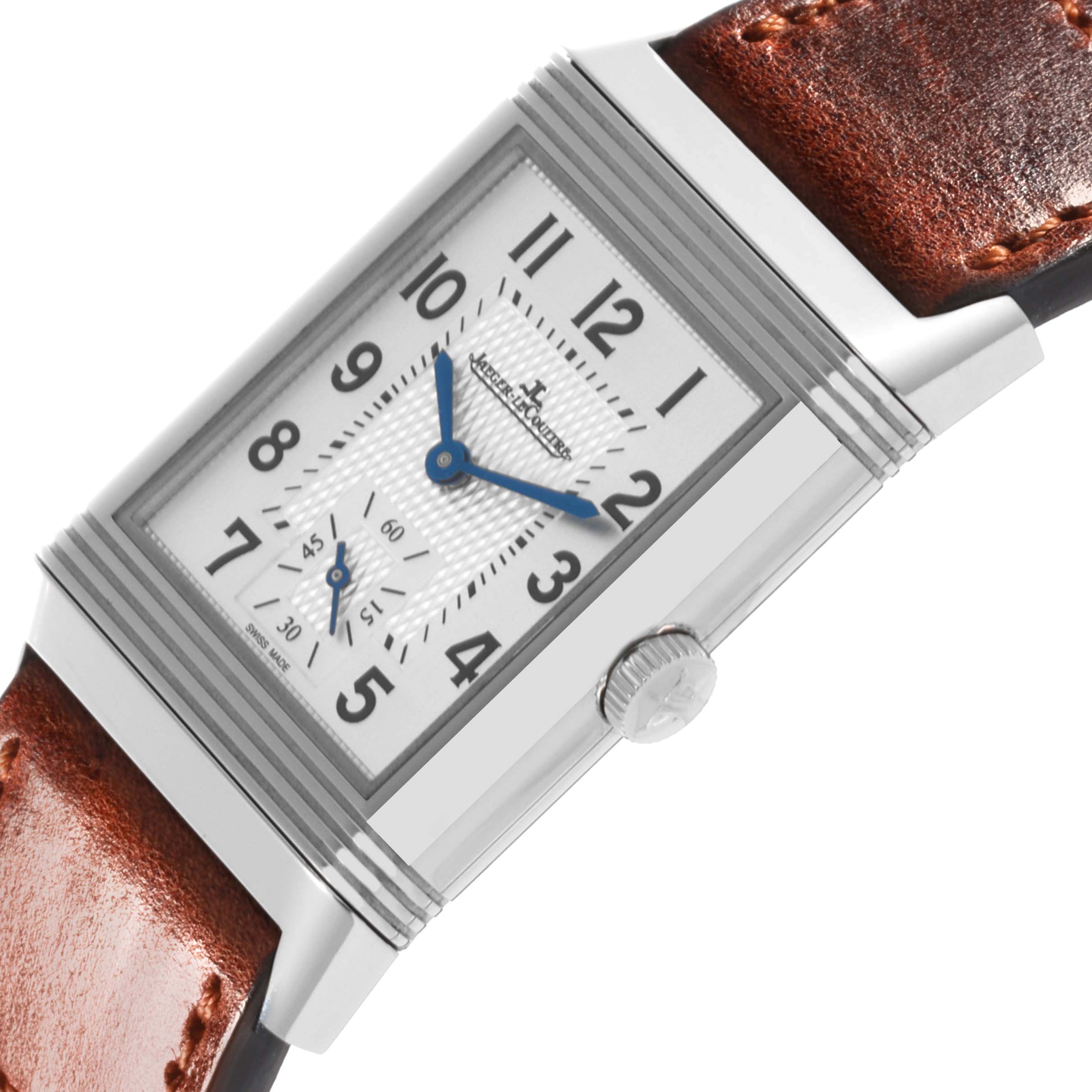 The Jaeger-LeCoultre Reverso watch is shown from a side angle, highlighting the crown, brown leather strap, and rectangular dial.