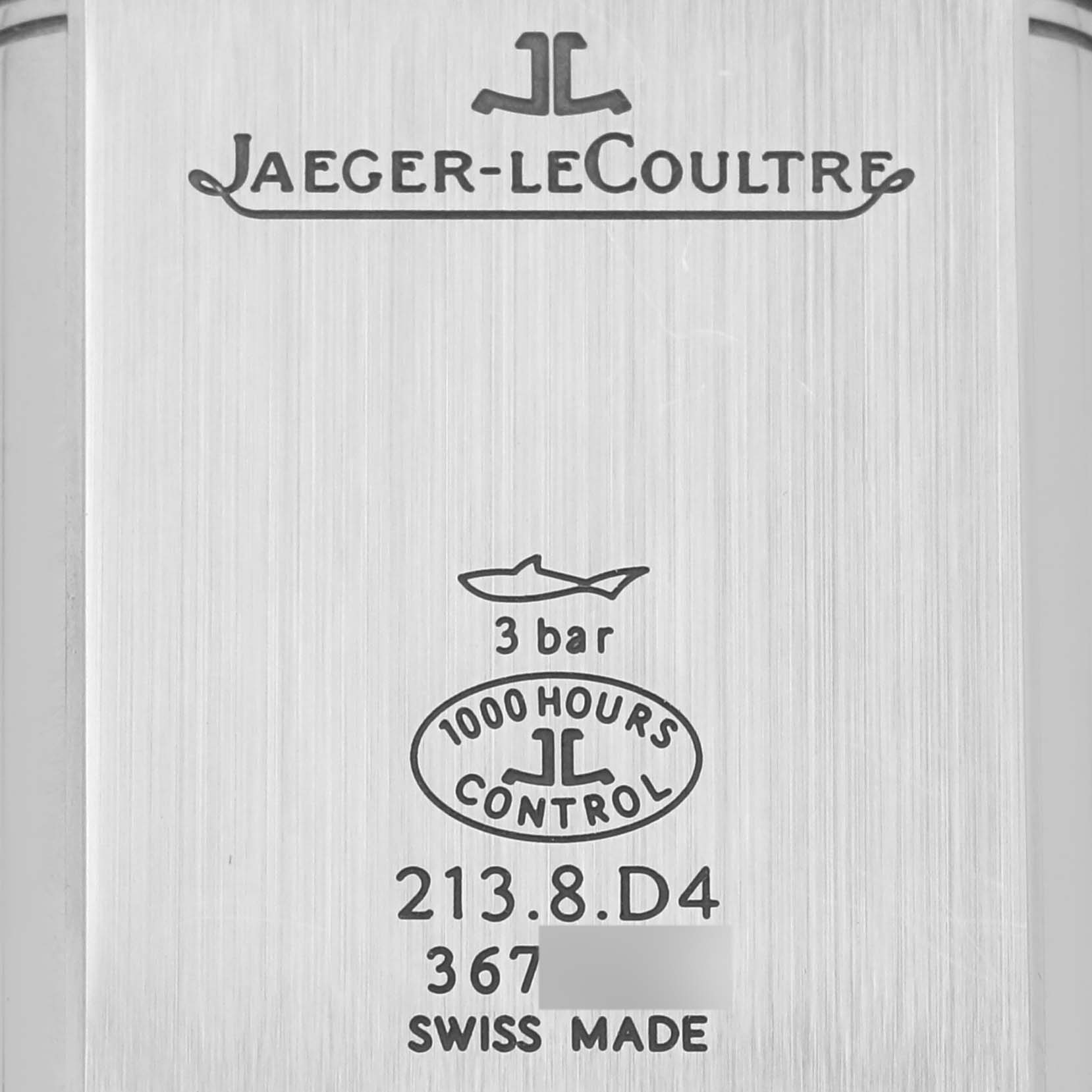 The image shows the back case of a Jaeger-LeCoultre Reverso watch, displaying brand logos and specifications.