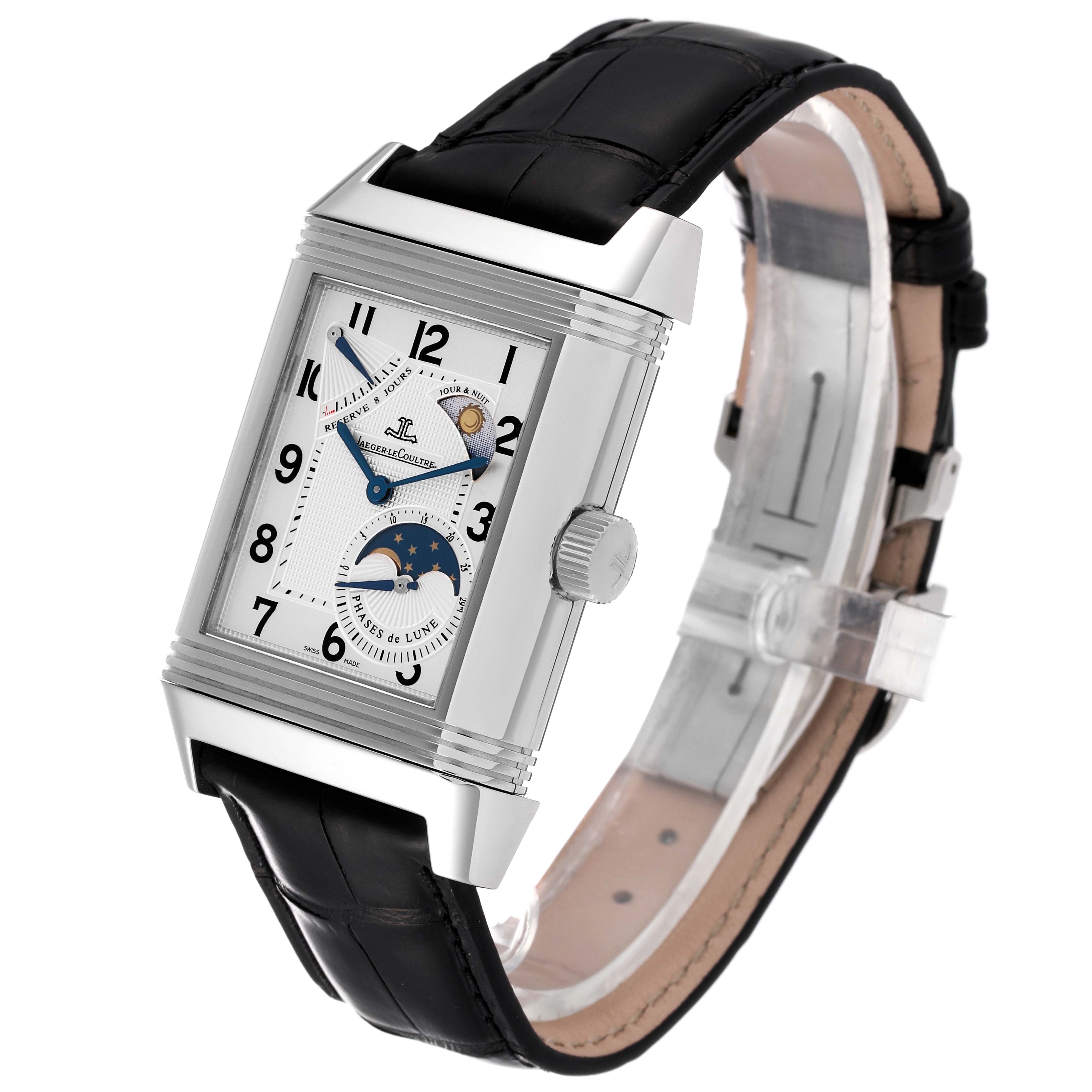 The Reverso model by Jaeger LeCoultre is shown at a three-quarter angle, featuring the watch face, moon phase, day-night indicator, and black leather strap.