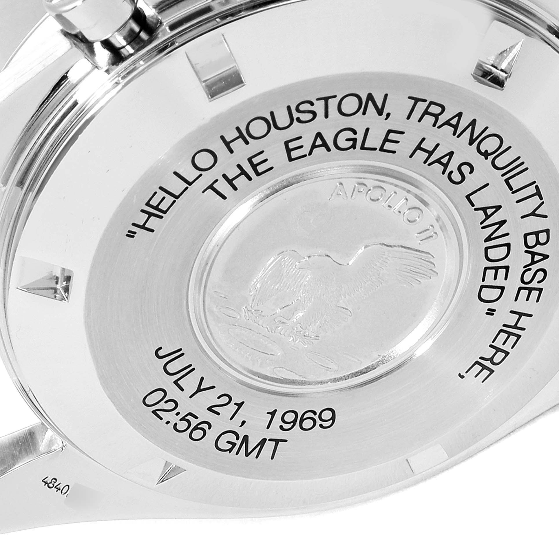 The image shows the back casing of an Omega Speedmaster 3560.50.00 Men's Stainless Steel Black Dial 3560.50.00 Men's Stainless Steel Black Dial watch, featuring the Apollo 11 emblem and engraved date and time.