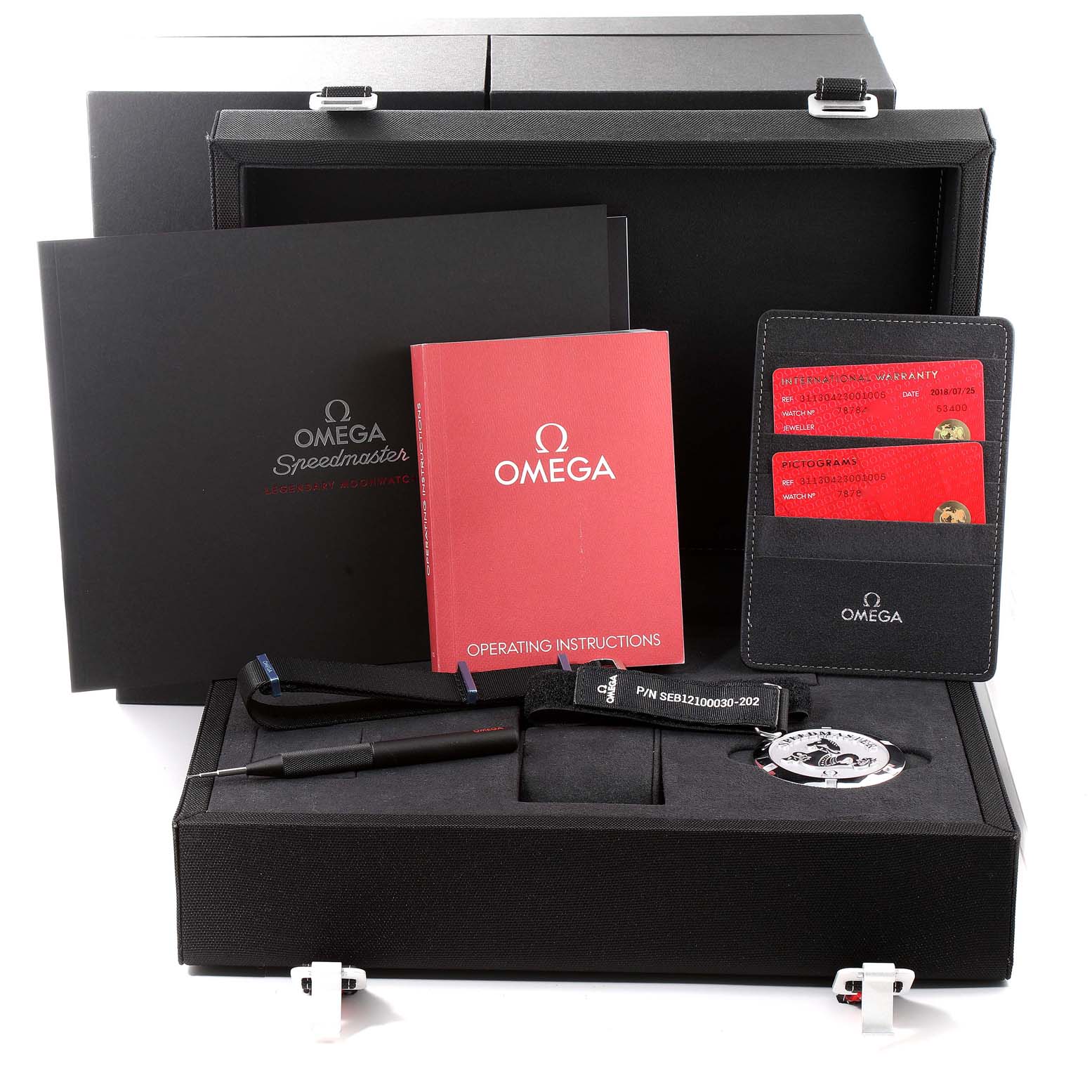 An Omega Speedmaster 311.30.42.30.01.005 Men's Stainless Steel Black Dial 311.30.42.30.01.005 Men's Stainless Steel Black Dial watch box with manuals, a warranty card holder, and watch accessories are shown from a high angle.