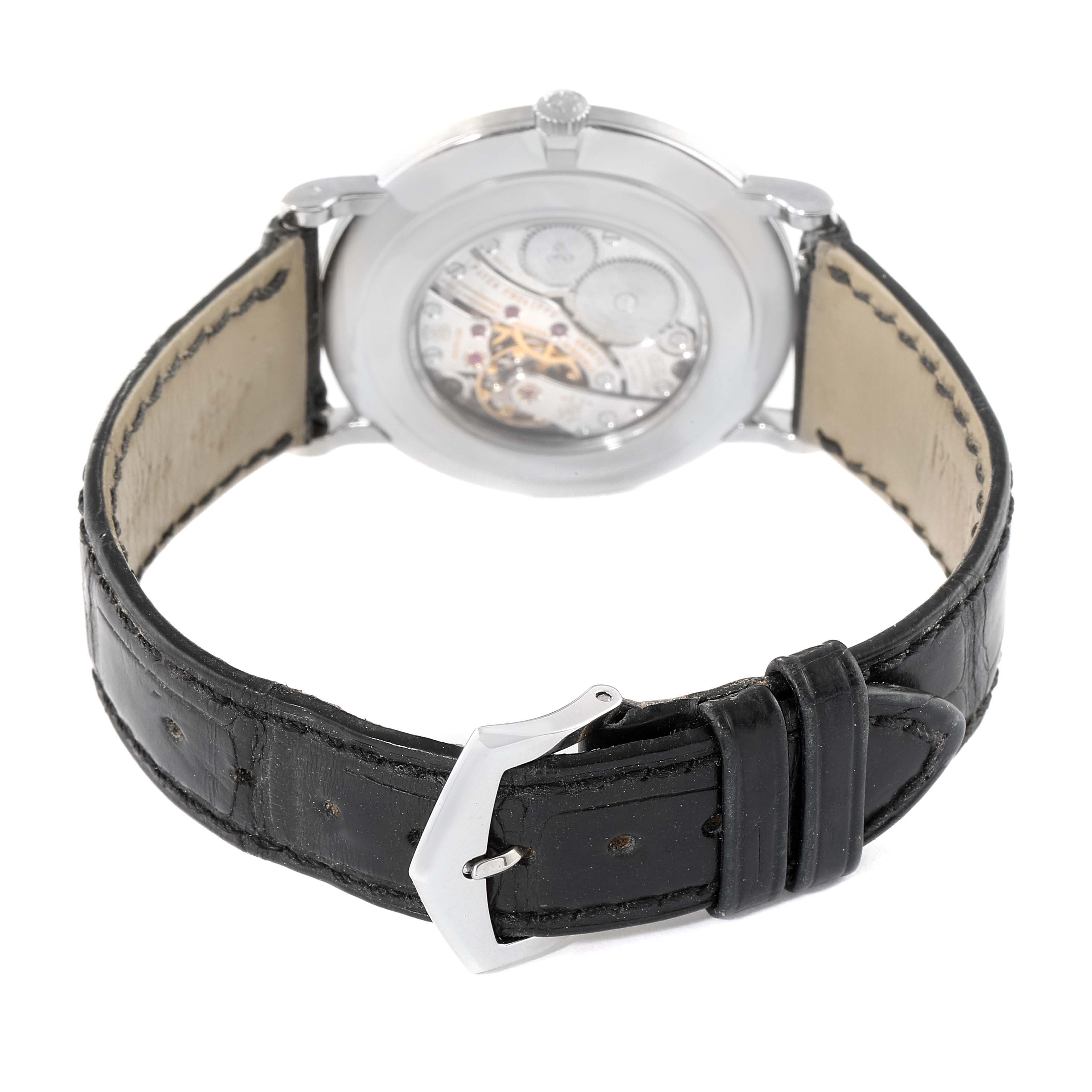 The image shows the back view of a Patek Philippe Calatrava 5119G Men's White Gold White Dial 5119G Men's White Gold White Dial watch, highlighting its transparent case back and leather strap.