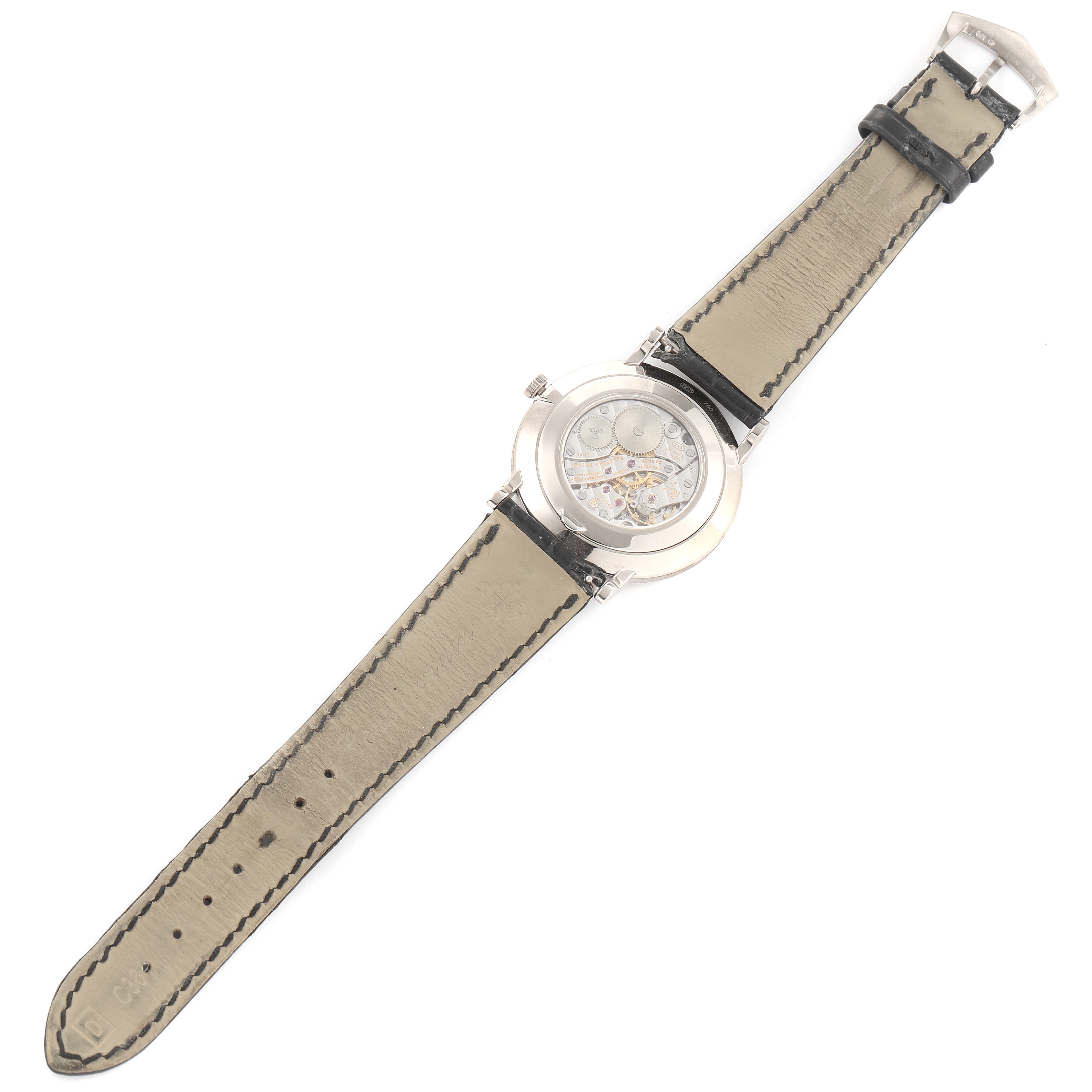 This image shows the back view of a Patek Philippe Calatrava 5119G Men's White Gold White Dial 5119G Men's White Gold White Dial watch, highlighting its open case back and leather strap.