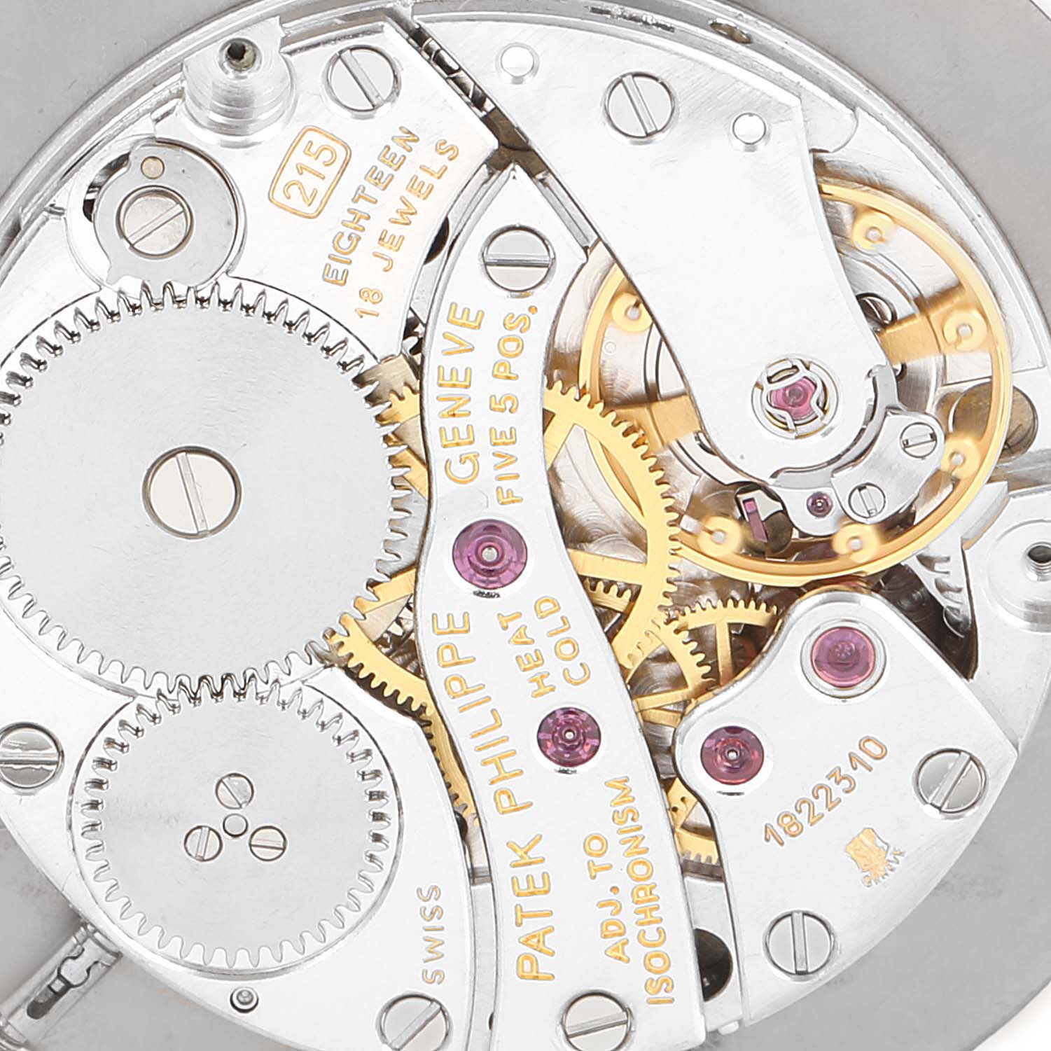 The image shows a close-up view of the intricate mechanical movement of a Patek Philippe Calatrava 3919 Men's Yellow Gold White Dial 3919 Men's Yellow Gold White Dial watch, highlighting the gears and engravings.