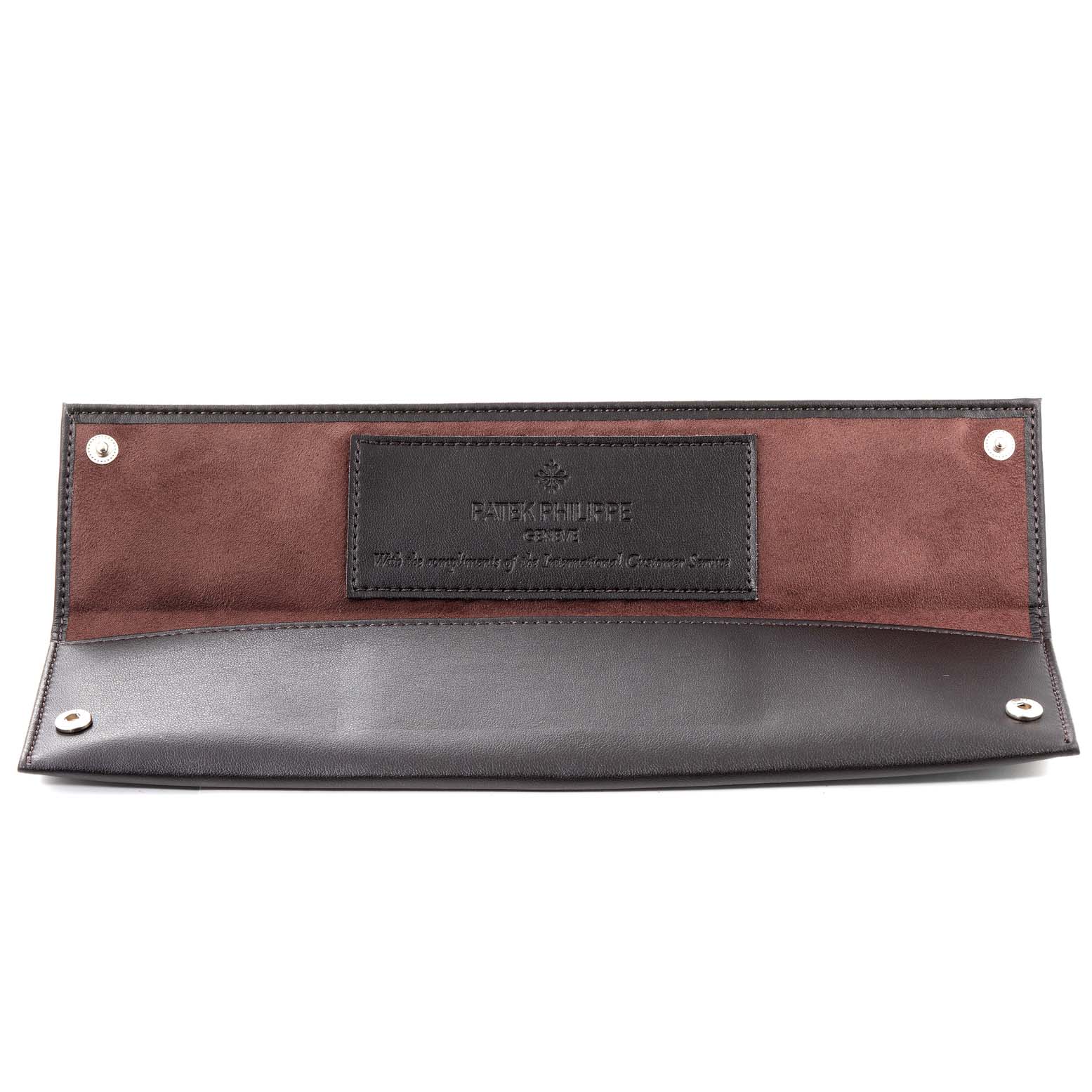 The image shows a Patek Philippe watch pouch for the Calatrava model, opened to display its interior.