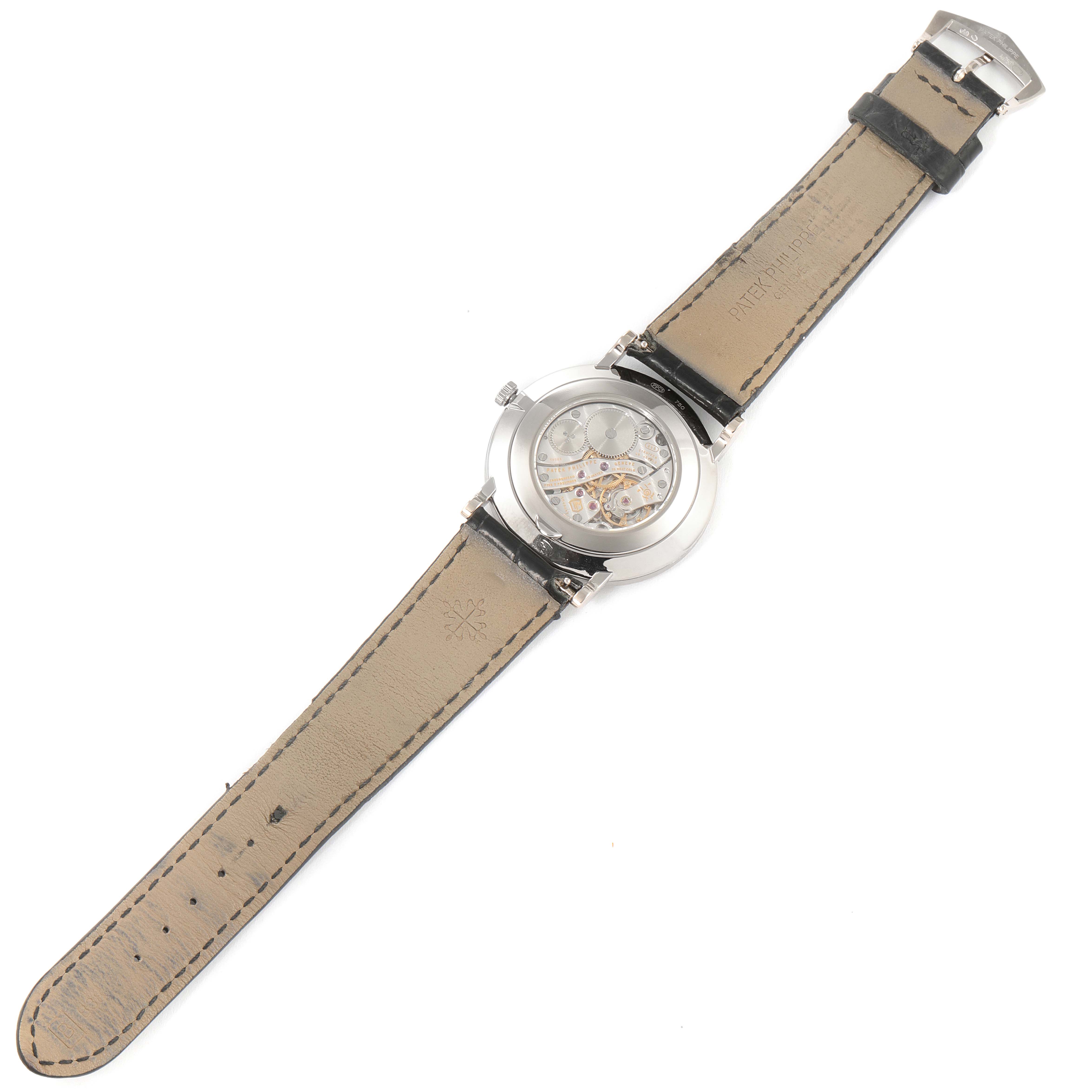 The image shows the back of a Patek Philippe Calatrava 5116G Men's White Gold White Dial 5116G Men's White Gold White Dial watch, highlighting its movement and leather straps.