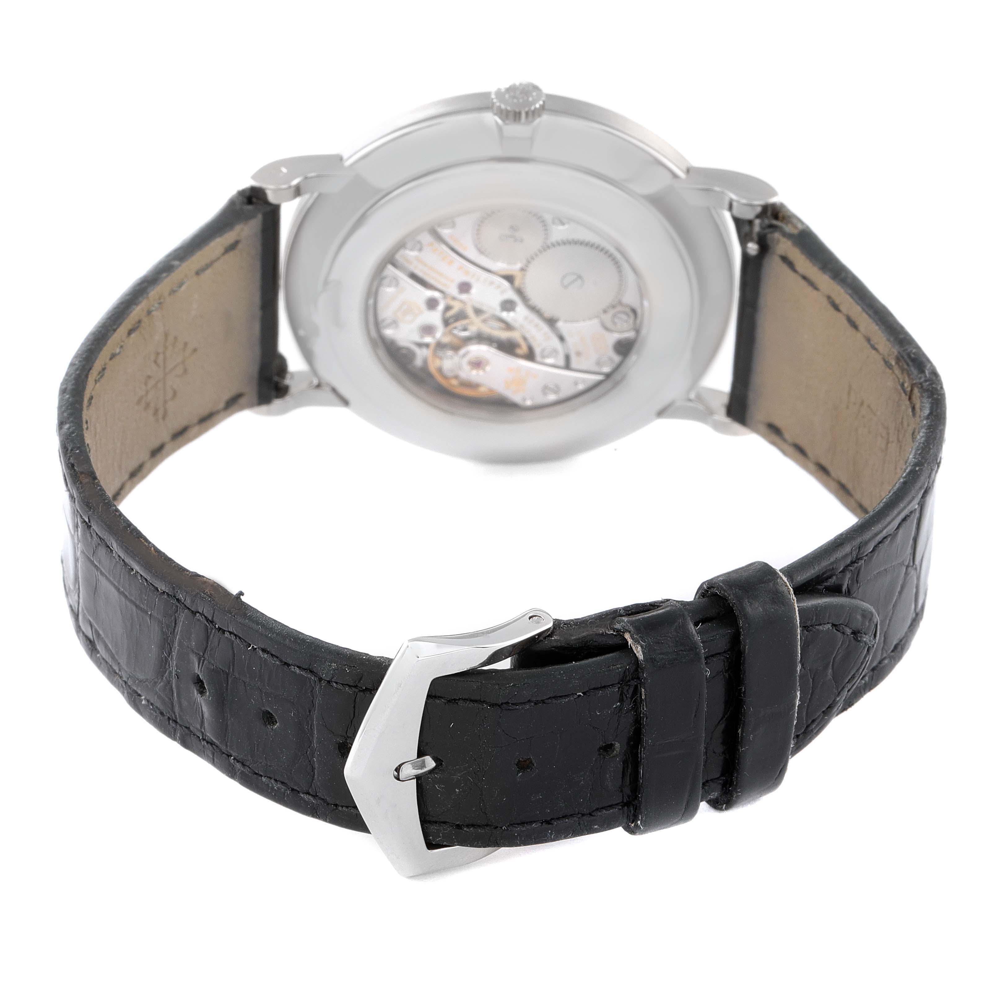 The image shows the back view of a Patek Philippe Calatrava 5116G Men's White Gold White Dial 5116G Men's White Gold White Dial watch, highlighting the caseback and black leather strap with a buckle.