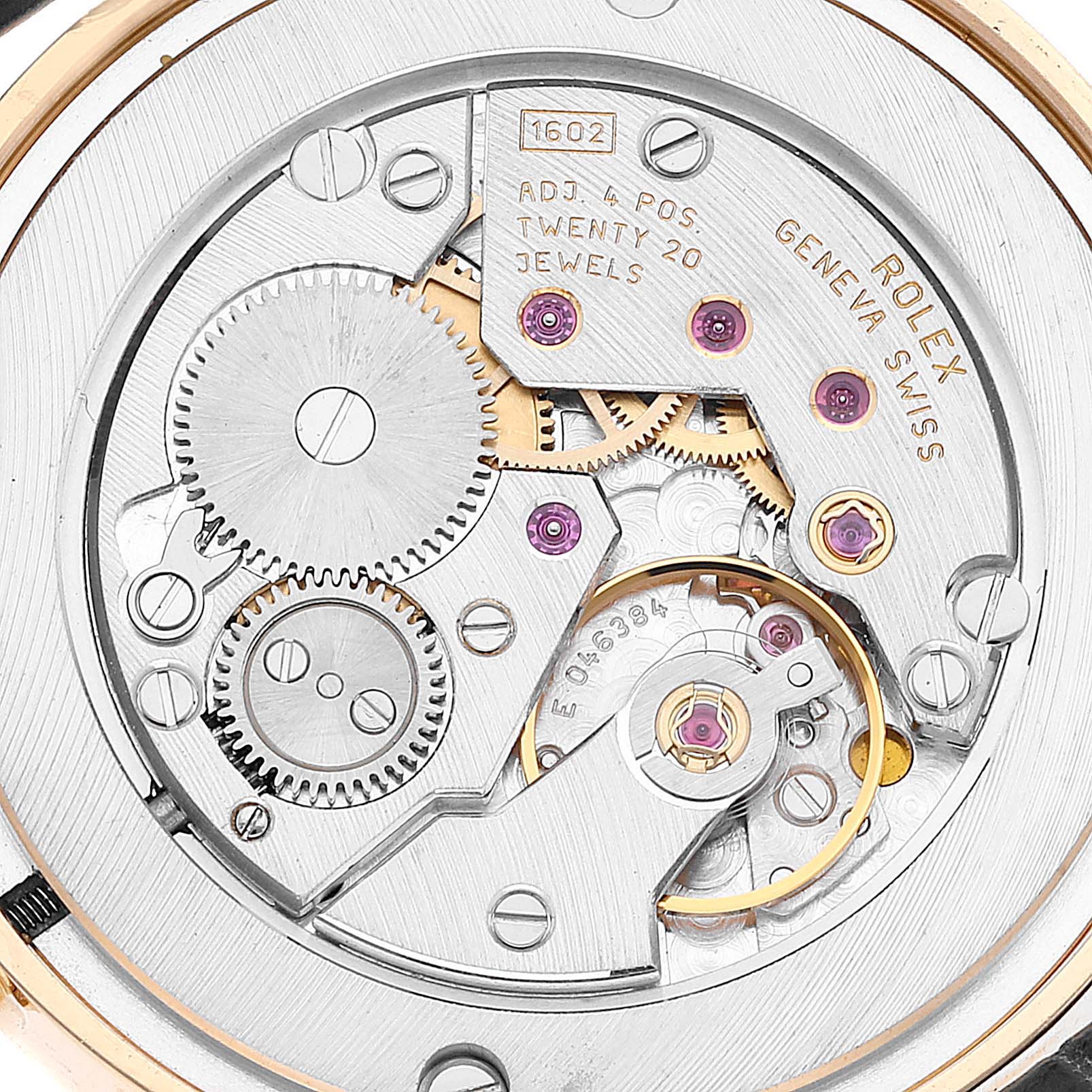 The image shows a close-up view of the movement mechanism of a Rolex Cellini 5115 Men's Yellow Gold Black Dial 5115 Men's Yellow Gold Black Dial watch, highlighting gears, jewels, and inscriptions.