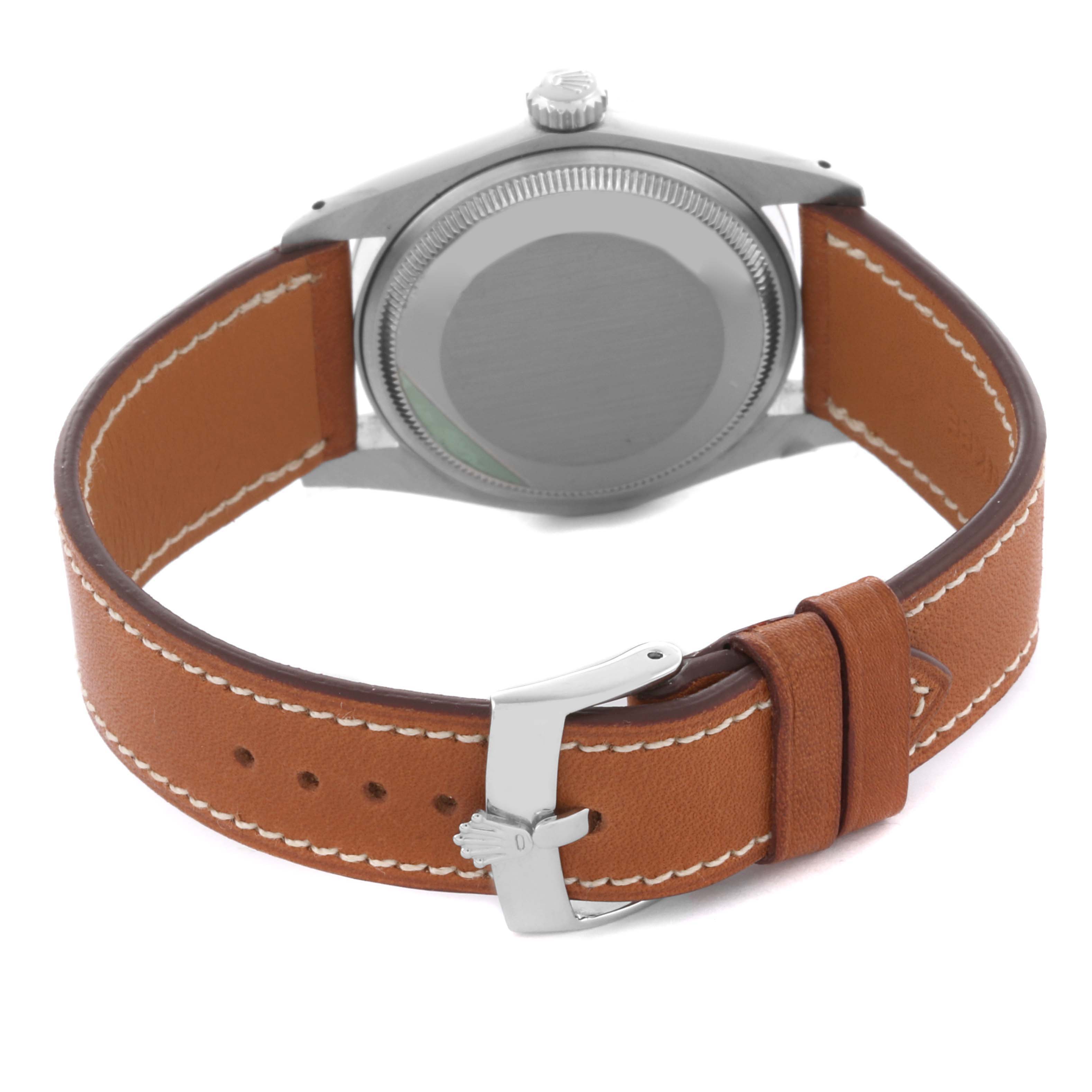 The image shows the back of a Rolex Date 1500 Men's Stainless Steel Silver Dial 1500 Men's Stainless Steel Silver Dial model, featuring its case, crown, and a brown leather strap with a buckle.