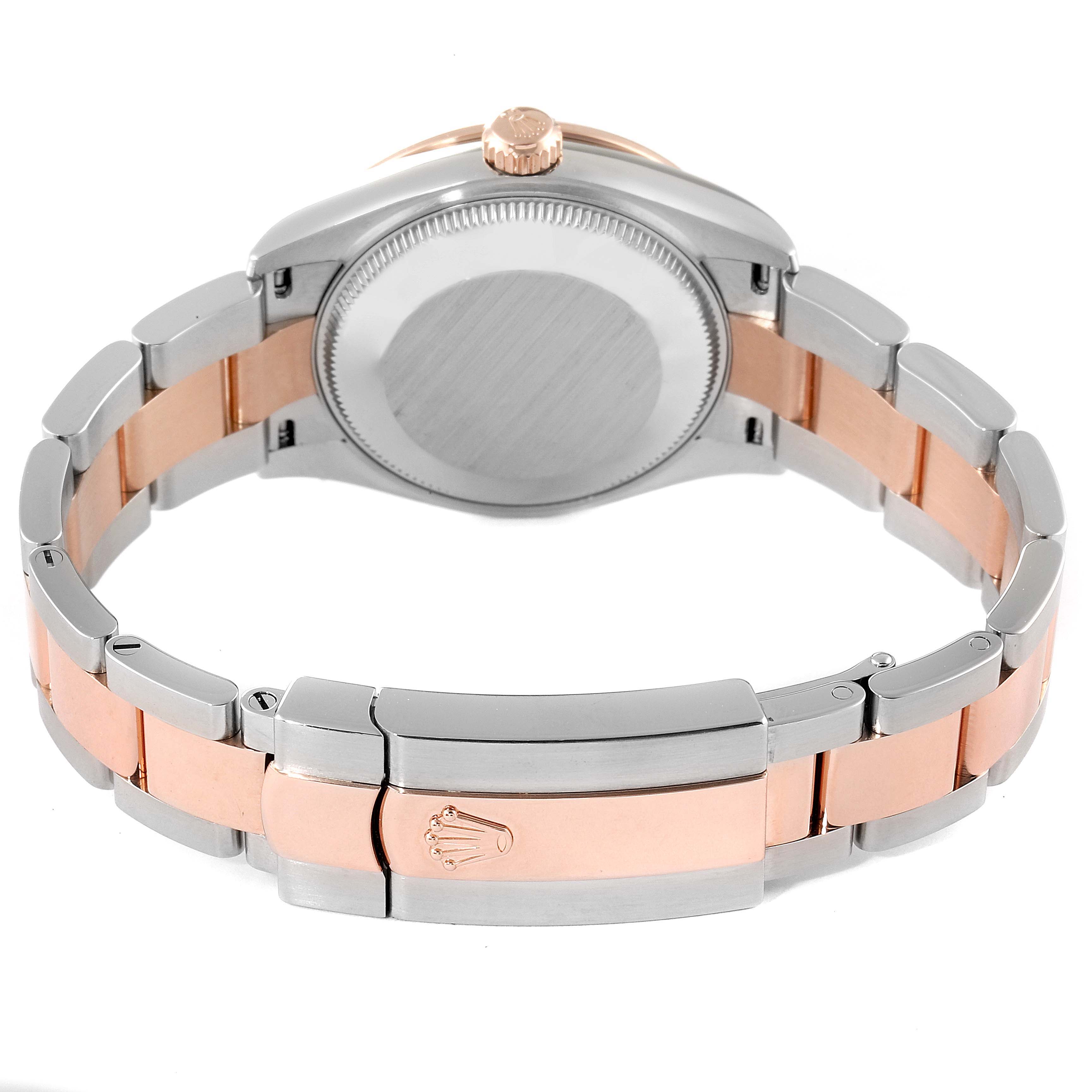 The image shows the back view of the Mid-Size Rolex watch, focusing on its case back, crown, and two-tone bracelet with clasp.