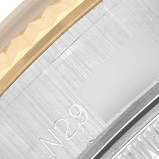 The image shows a close-up of the Rolex Datejust 69173 Women's Steel and Gold (two tone) Black Dial 69173 Women's Steel and Gold (two tone) Black Dial's bezel and edge of the bracelet, highlighting the metal texture and engravings.