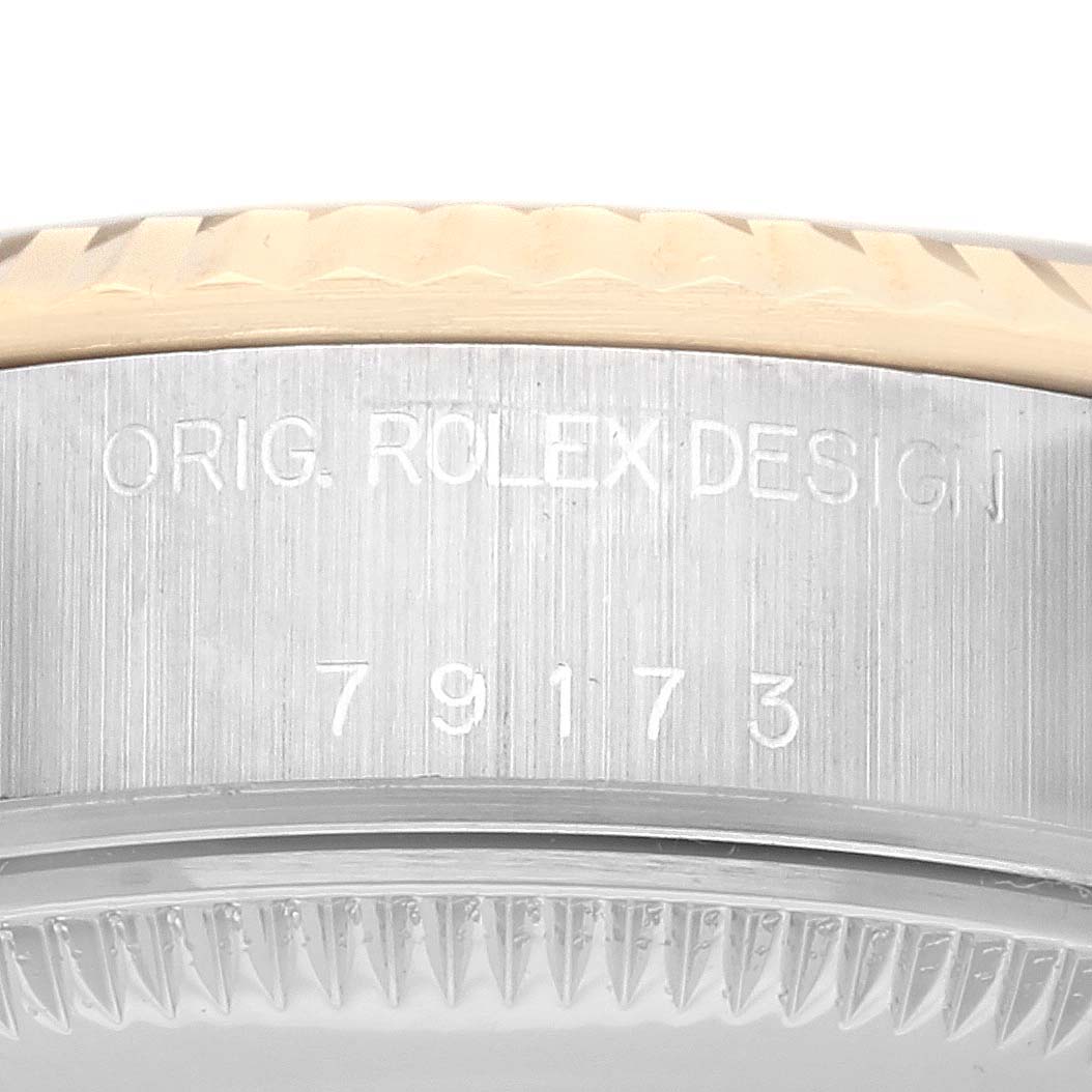 This image shows the side view of the case of a Rolex Datejust 79173 Women's Steel and Gold (two tone) Champagne Dial 79173 Women's Steel and Gold (two tone) Champagne Dial, focusing on the engraved serial number.