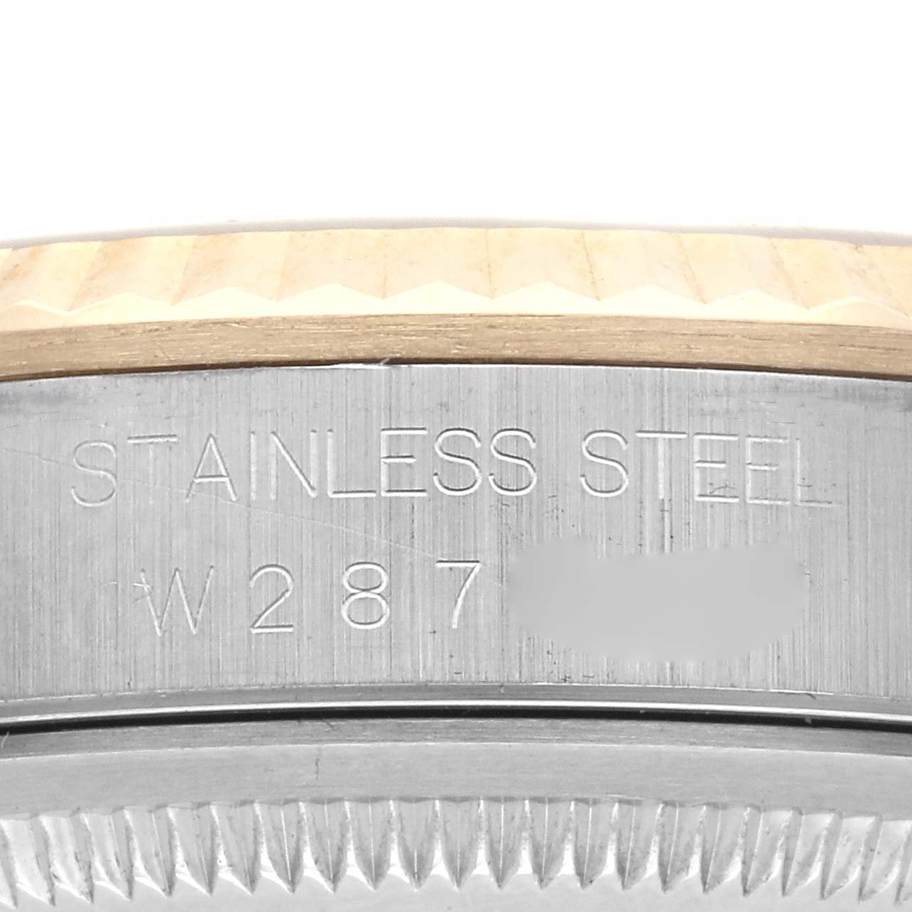 This close-up image of the Rolex Datejust 16233 Men
s Steel and Gold (two tone) Champagne Dial 16233 Men
s Steel and Gold (two tone) Champagne Dial watch shows the stainless steel case and a section of the fluted bezel from the side angle.