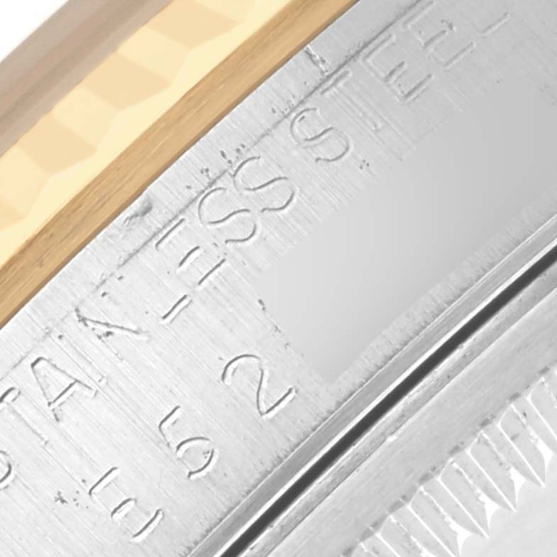 The image shows a close-up of the engraved stainless steel casing and bezel of the Rolex Datejust 16233 Men's Steel and Gold (two tone) Champagne Dial 16233 Men's Steel and Gold (two tone) Champagne Dial.