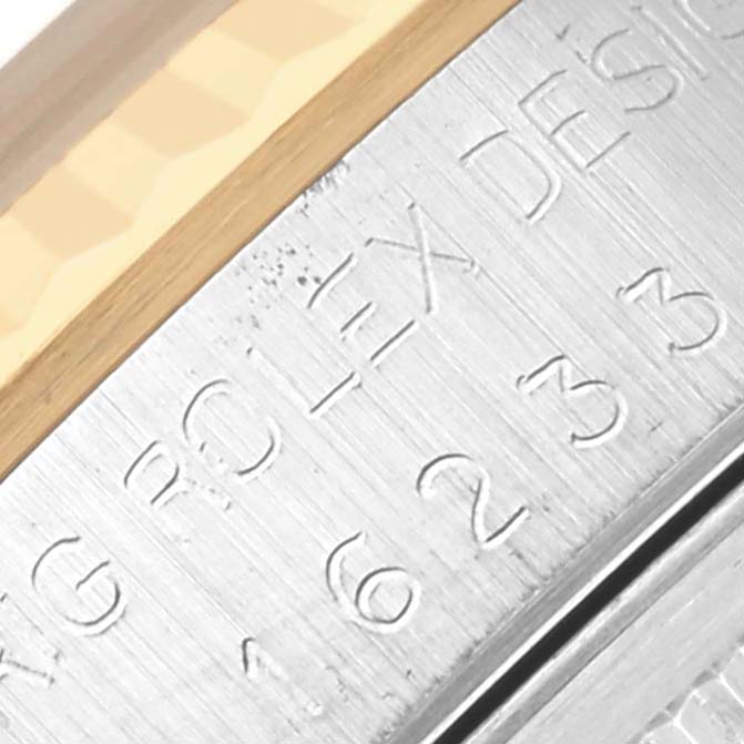 The image shows a close-up of the case side of a Rolex Datejust 16233 Men's Steel and Gold (two tone) Champagne Dial 16233 Men's Steel and Gold (two tone) Champagne Dial, featuring the serial engraving.