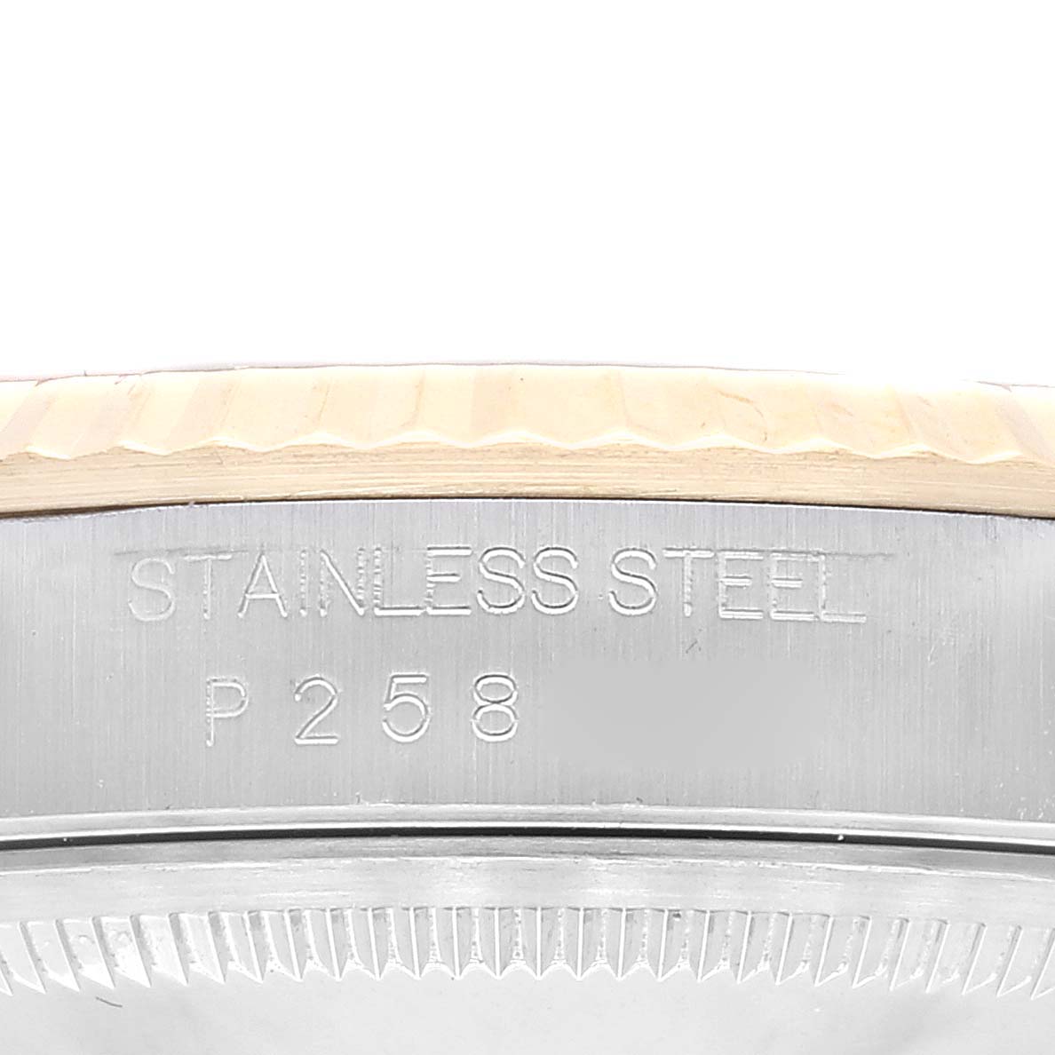 This image shows a close-up view of the stainless steel marking and part of the bezel of a Rolex Datejust 16233 Men's Steel and Gold (two tone) Champagne Dial 16233 Men's Steel and Gold (two tone) Champagne Dial watch.