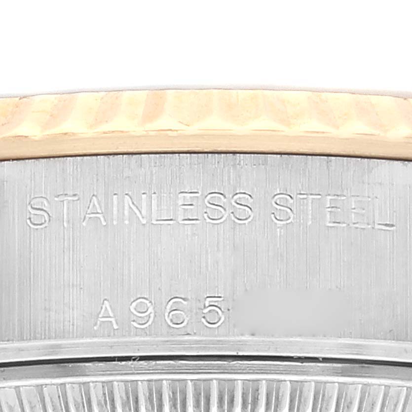 The image shows a close-up of the side of a Rolex Datejust 79173 Women's Steel and Gold (two tone) Grey Dial 79173 Women's Steel and Gold (two tone) Grey Dial watch, highlighting the "STAINLESS STEEL" engraving and part of the bezel.
