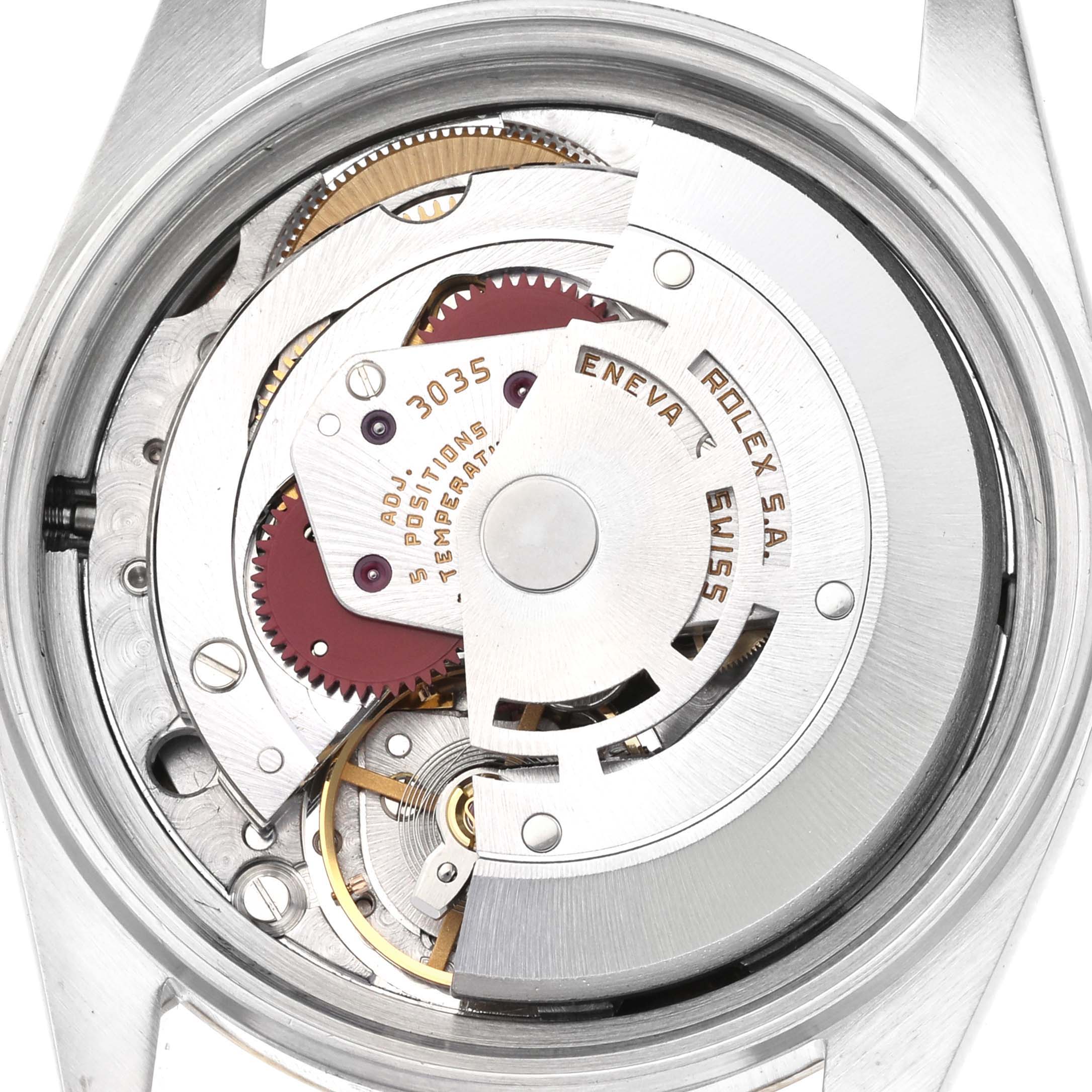 The image shows the movement of a Rolex Datejust 16013 Men
s Steel and Gold (two tone) Champagne Dial 16013 Men
s Steel and Gold (two tone) Champagne Dial watch from the back, featuring gears and the rotor.
