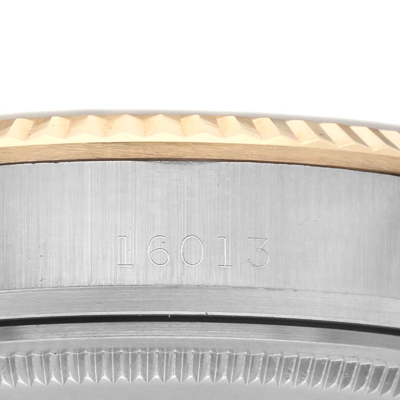 The image shows a close-up side view of the case and fluted bezel of a Rolex Datejust 16013 Men
s Steel and Gold (two tone) Champagne Dial 16013 Men
s Steel and Gold (two tone) Champagne Dial watch, with the model number 16013 engraved.