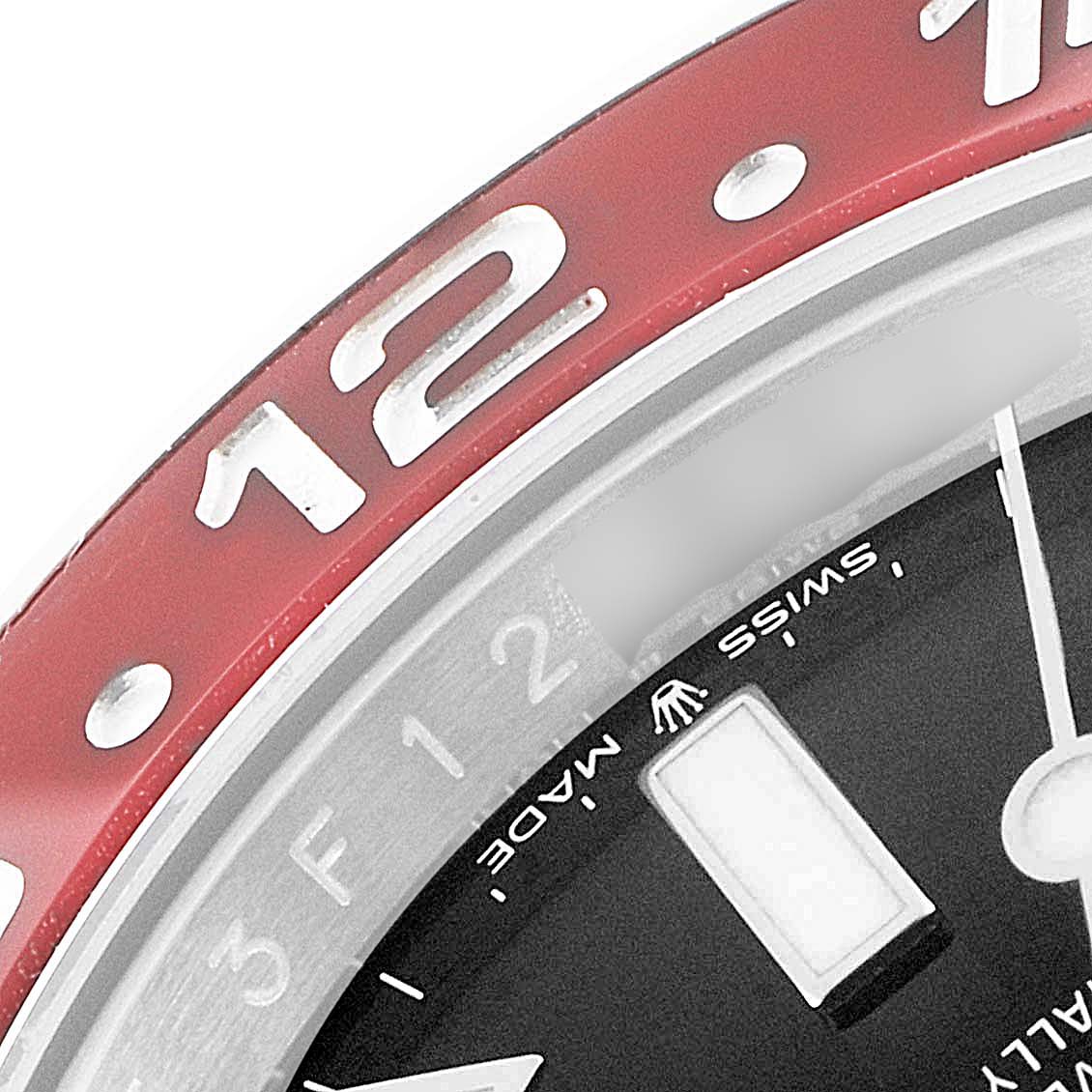 This image shows a close-up of the bezel and part of the dial of a Rolex GMT-Master 126710 Men's Stainless Steel Black Dial 126710 Men's Stainless Steel Black Dial watch.