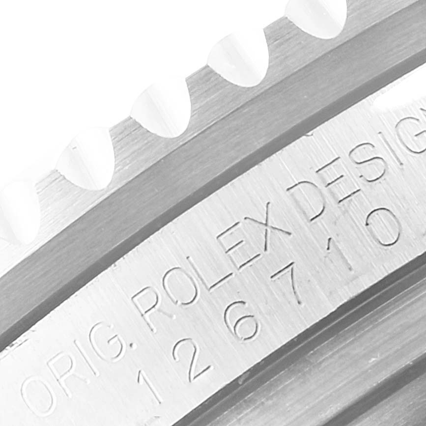 The image shows a close-up of the bezel and engraved serial number on a Rolex GMT-Master 126710 Men's Stainless Steel Black Dial 126710 Men's Stainless Steel Black Dial watch.