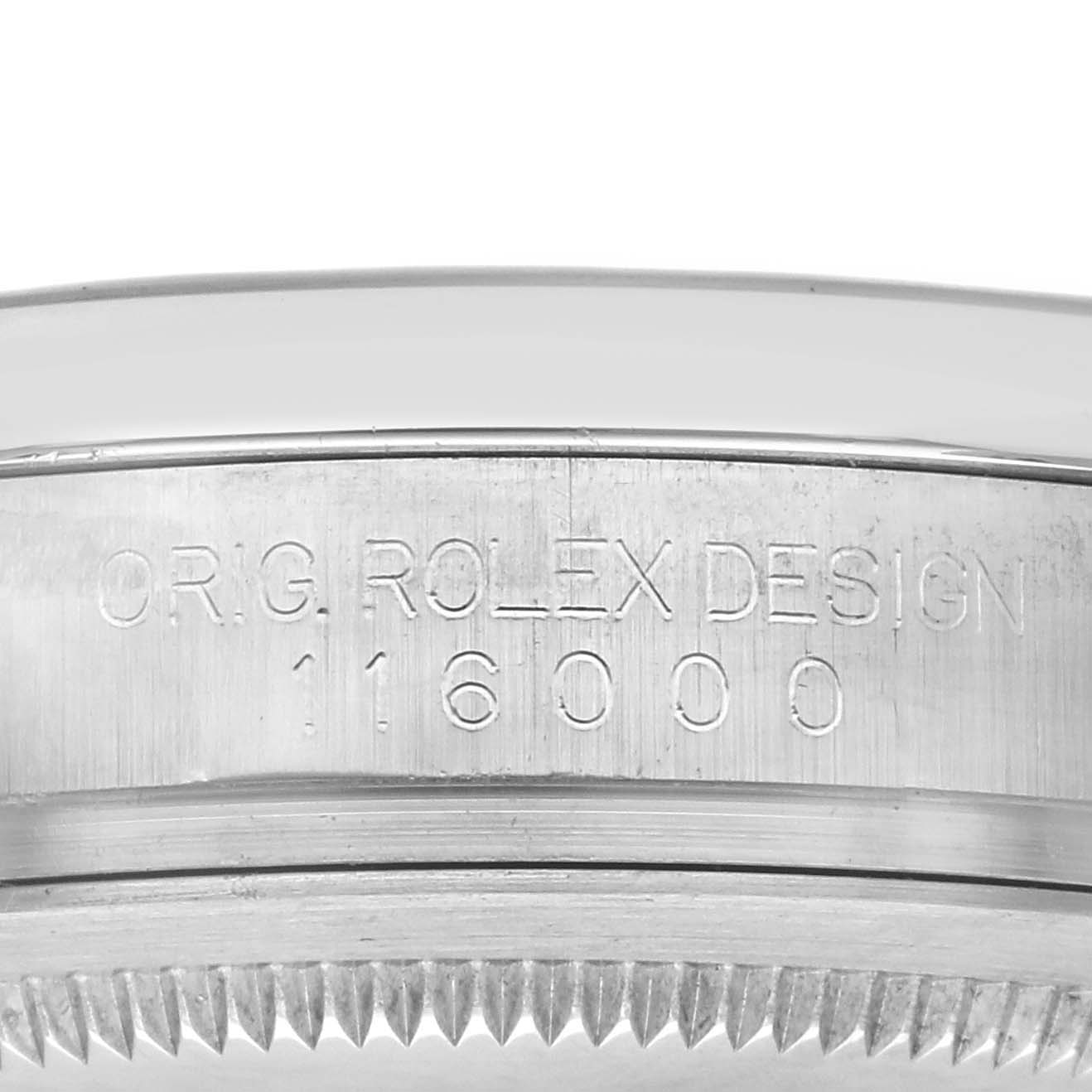 The image shows a side view of the serial number engraving on a Rolex Oyster Perpetual 116000 Men's Stainless Steel Silver Dial 116000 Men's Stainless Steel Silver Dial watch case.