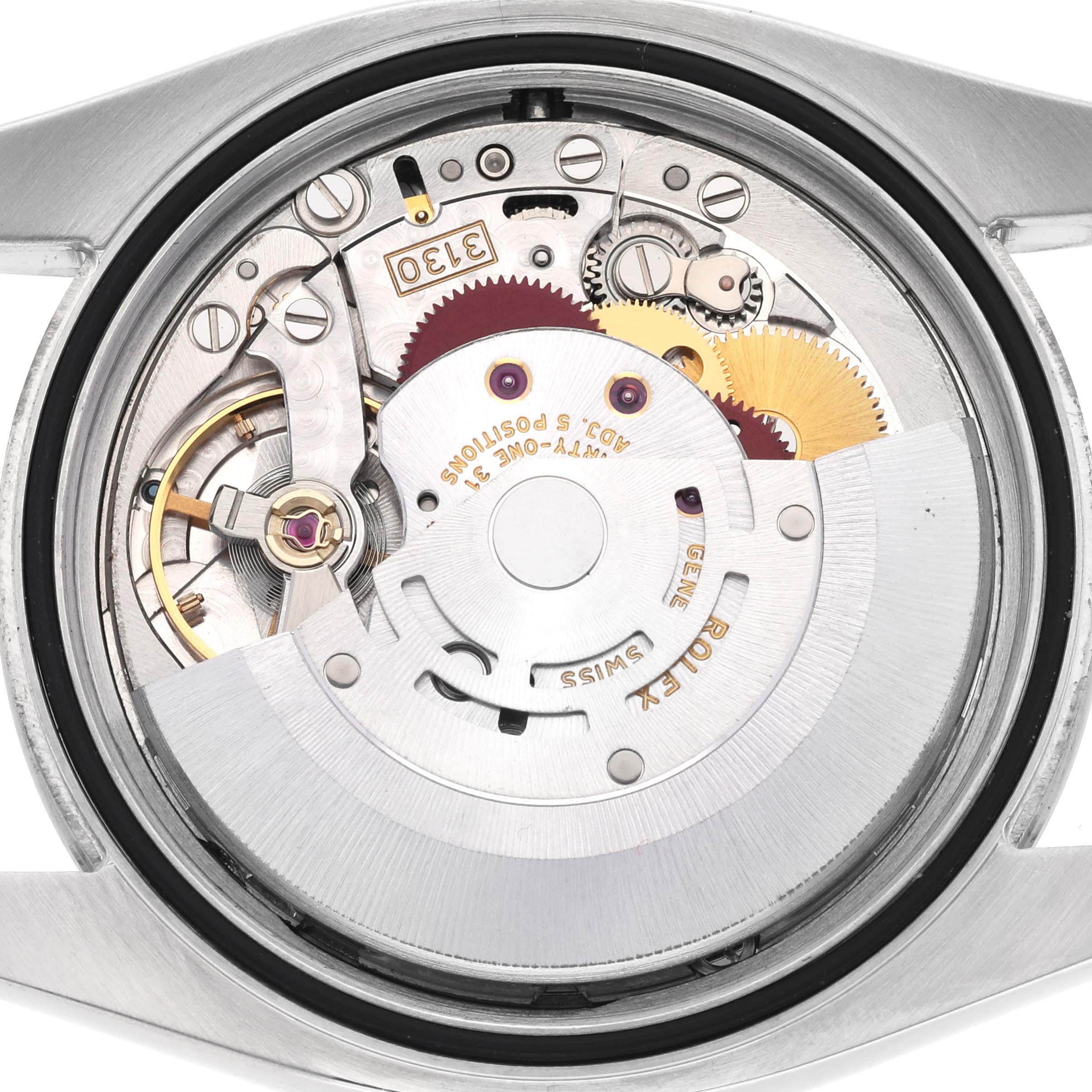 The Rolex Oyster Perpetual 116000 Men's Stainless Steel Silver Dial 116000 Men's Stainless Steel Silver Dial model is shown from the back, displaying its intricate movement and gears.