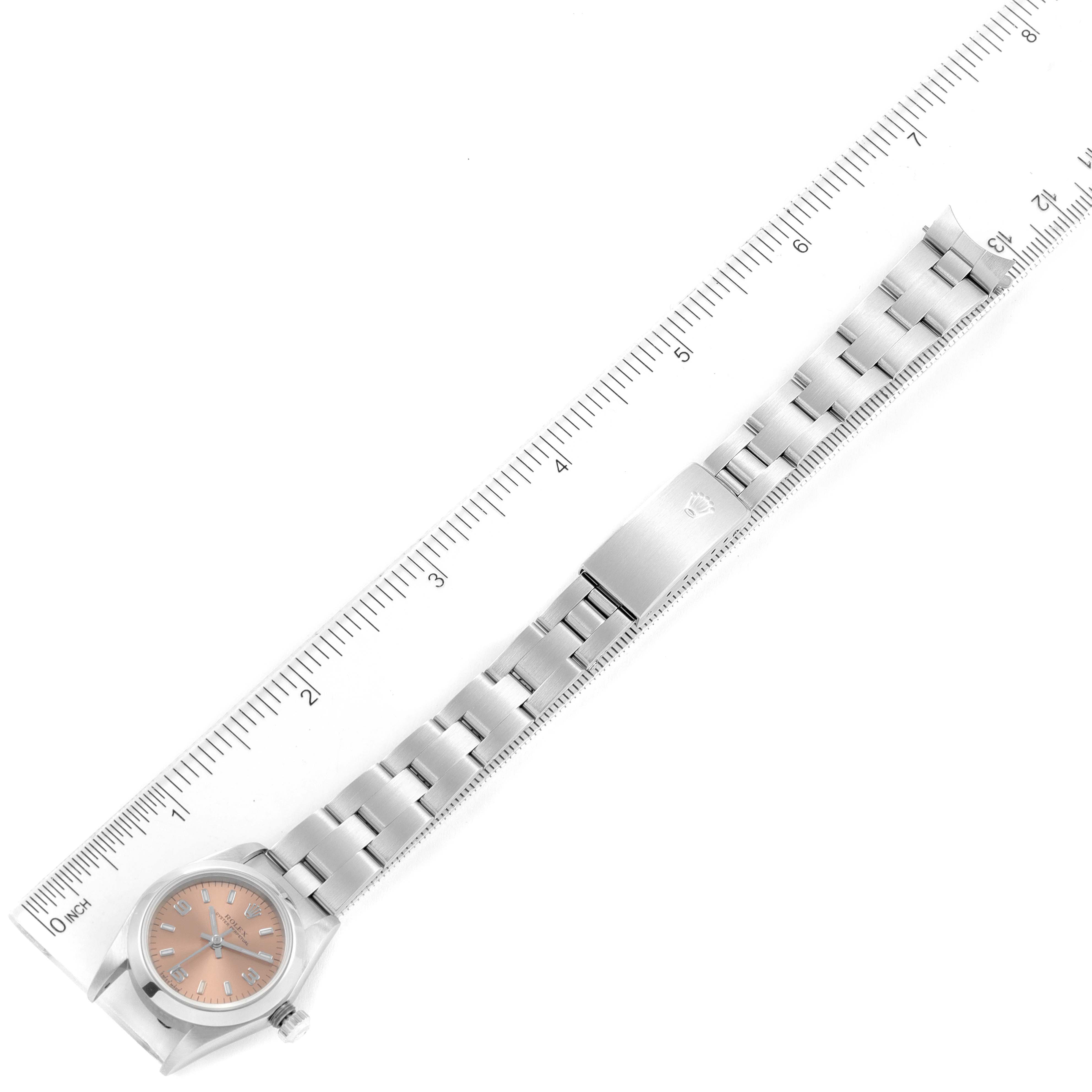 This image shows the face, bracelet, and clasp of the Rolex Oyster Perpetual 76080 Women's Stainless Steel Pink Dial 76080 Women's Stainless Steel Pink Dial watch taken from the top with a ruler for scale.