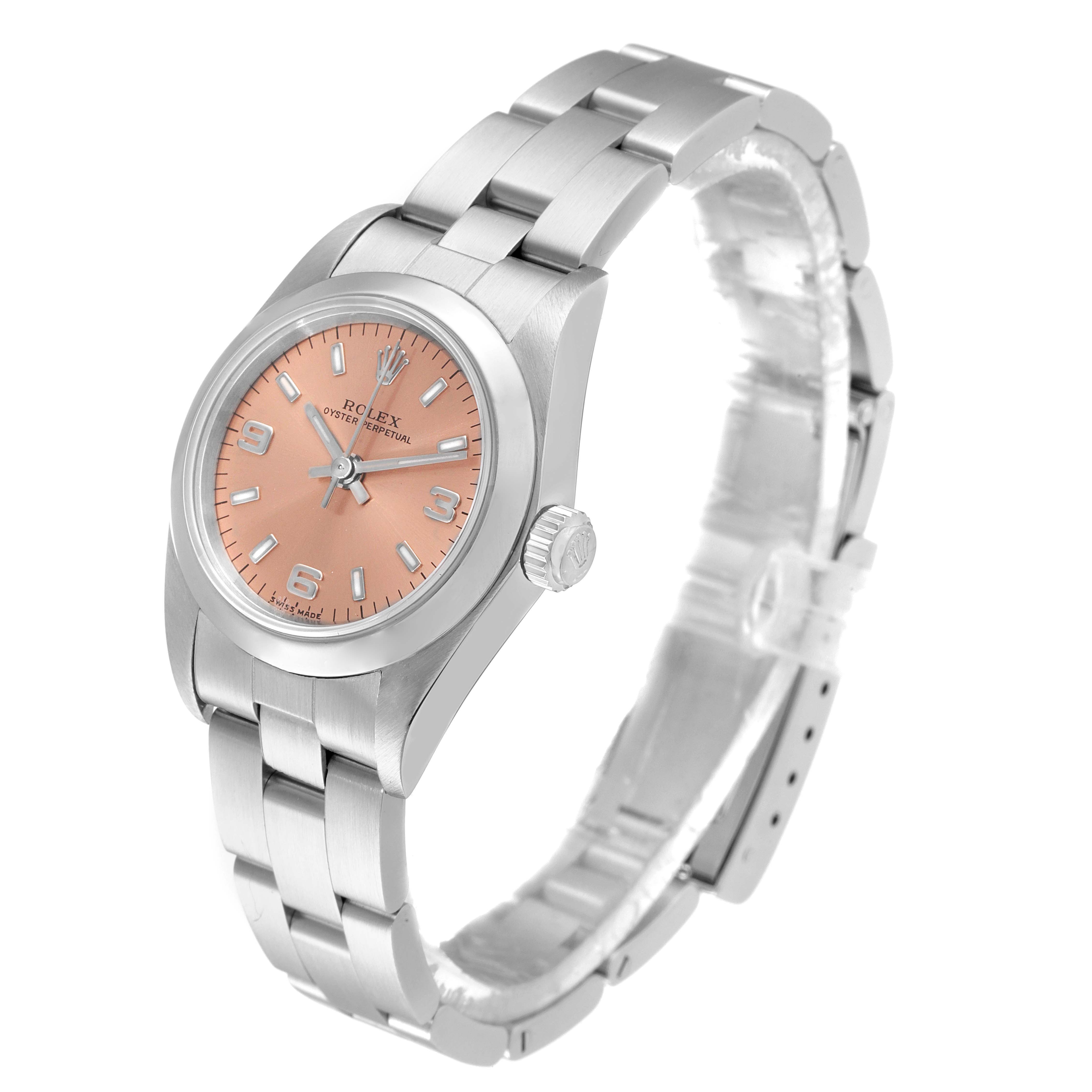 The Rolex Oyster Perpetual 76080 Women's Stainless Steel Pink Dial 76080 Women's Stainless Steel Pink Dial watch is shown at a slight angle featuring its pink dial, crown, and stainless steel bracelet.