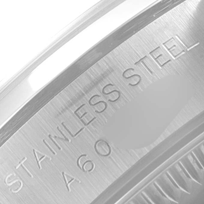 The image shows a close-up of the stainless steel engraving inside the casing of a Rolex Oyster Perpetual 76080 Women's Stainless Steel Pink Dial 76080 Women's Stainless Steel Pink Dial watch.