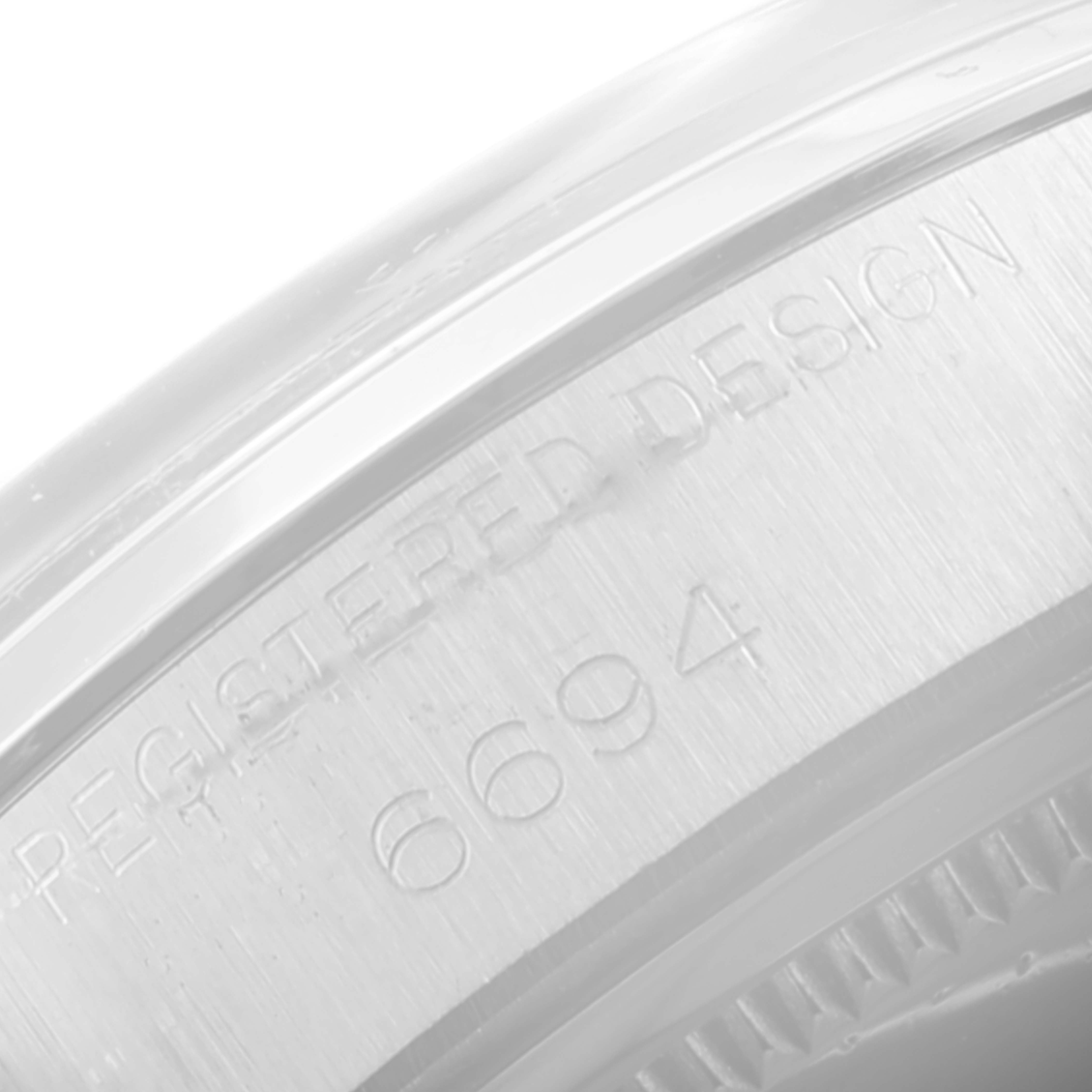 The image shows a close-up of the casing side of a Rolex Vintage Collection 6694 Men's Stainless Steel Silver Dial 6694 Men's Stainless Steel Silver Dial model, displaying the text "REGISTERED DESIGN 6694."