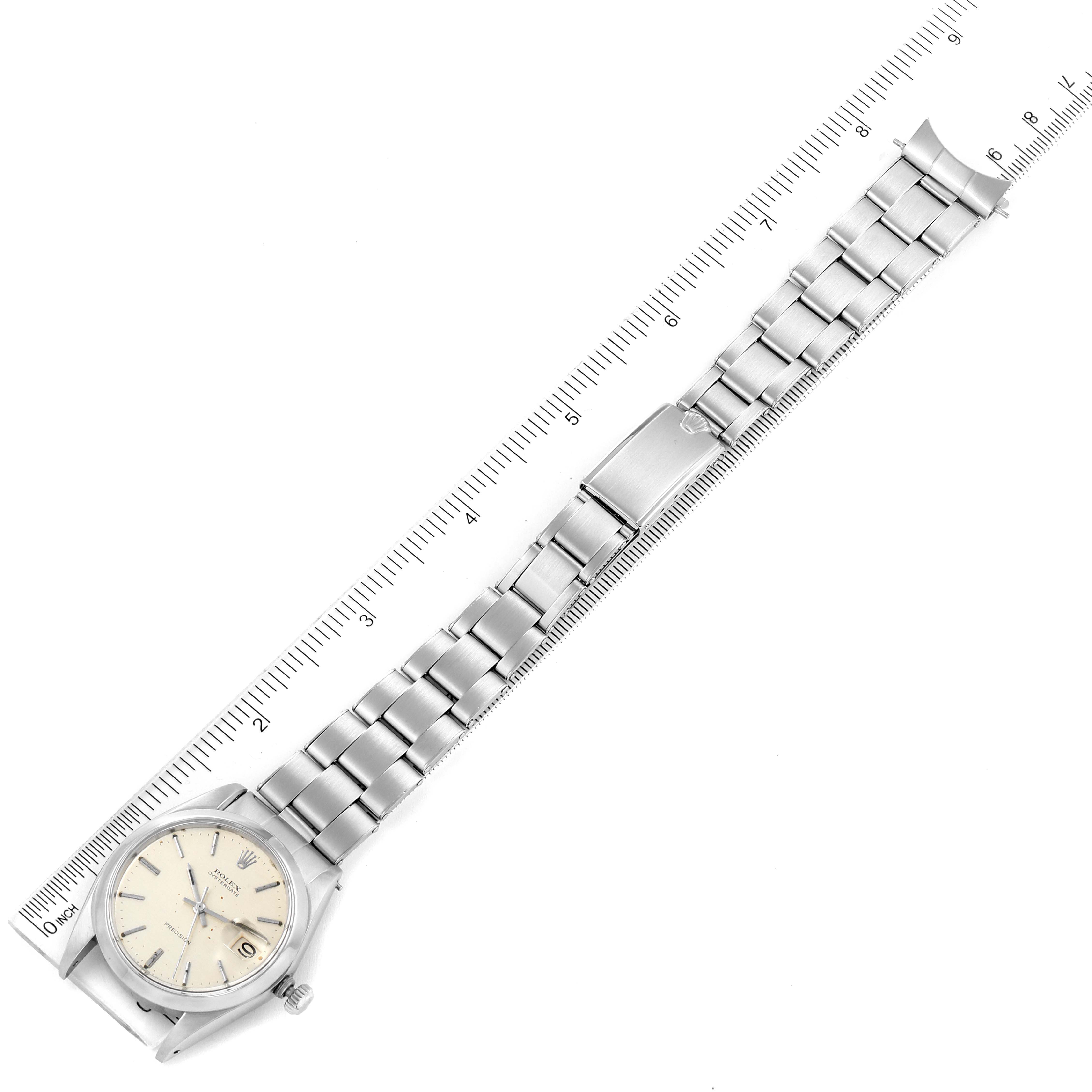 The Rolex Vintage Collection 6694 Men's Stainless Steel Silver Dial 6694 Men's Stainless Steel Silver Dial model watch is shown laid out flat with its bracelet extended alongside a ruler for size reference.