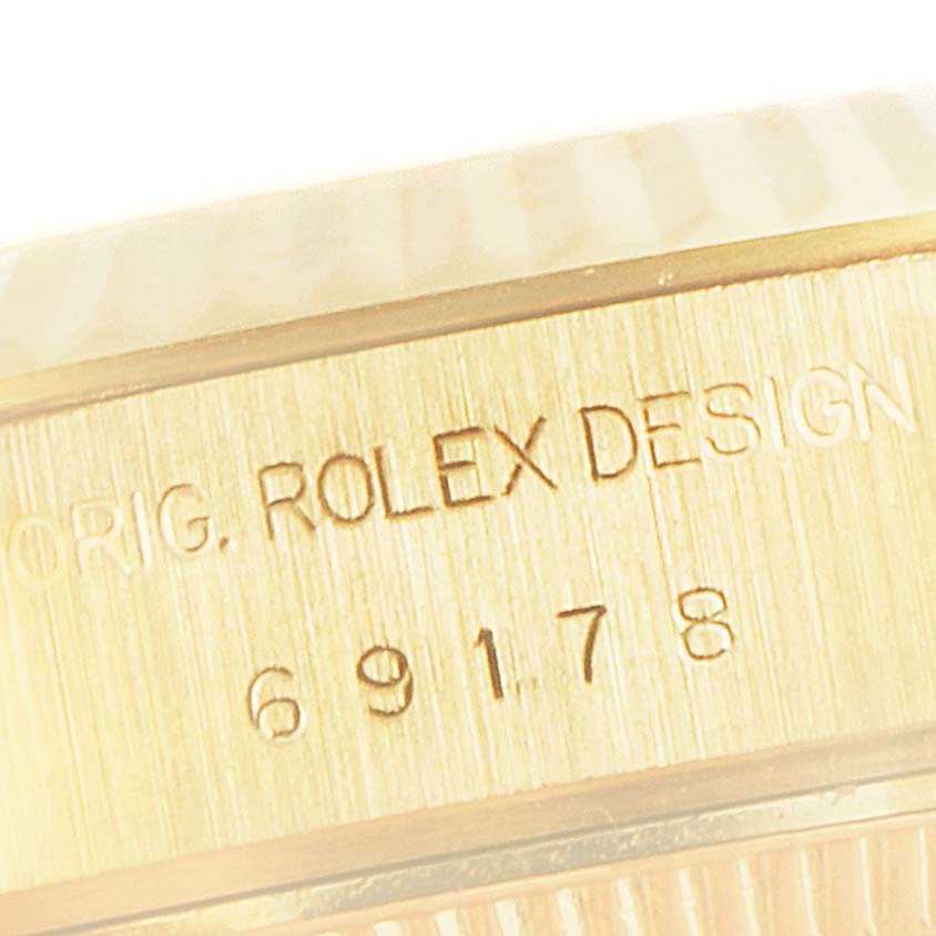 This close-up image shows the engraved model number and design details on the bezel of a Rolex President 69178 Women's Yellow Gold White Dial 69178 Women's Yellow Gold White Dial watch.