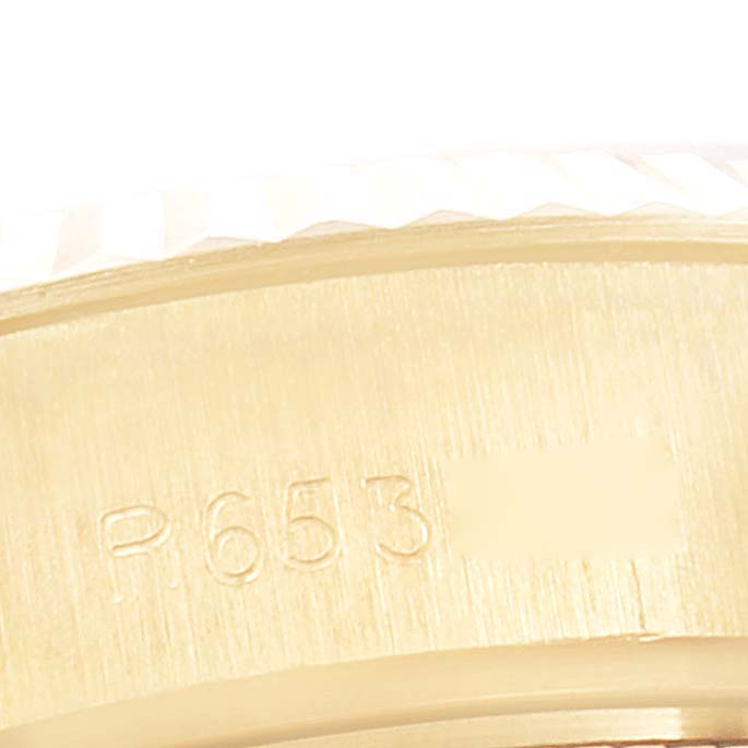 This close-up image shows the side of a Rolex President 69178 Women's Yellow Gold Champagne Dial 69178 Women's Yellow Gold Champagne Dial model, focusing on the serial number engraving.
