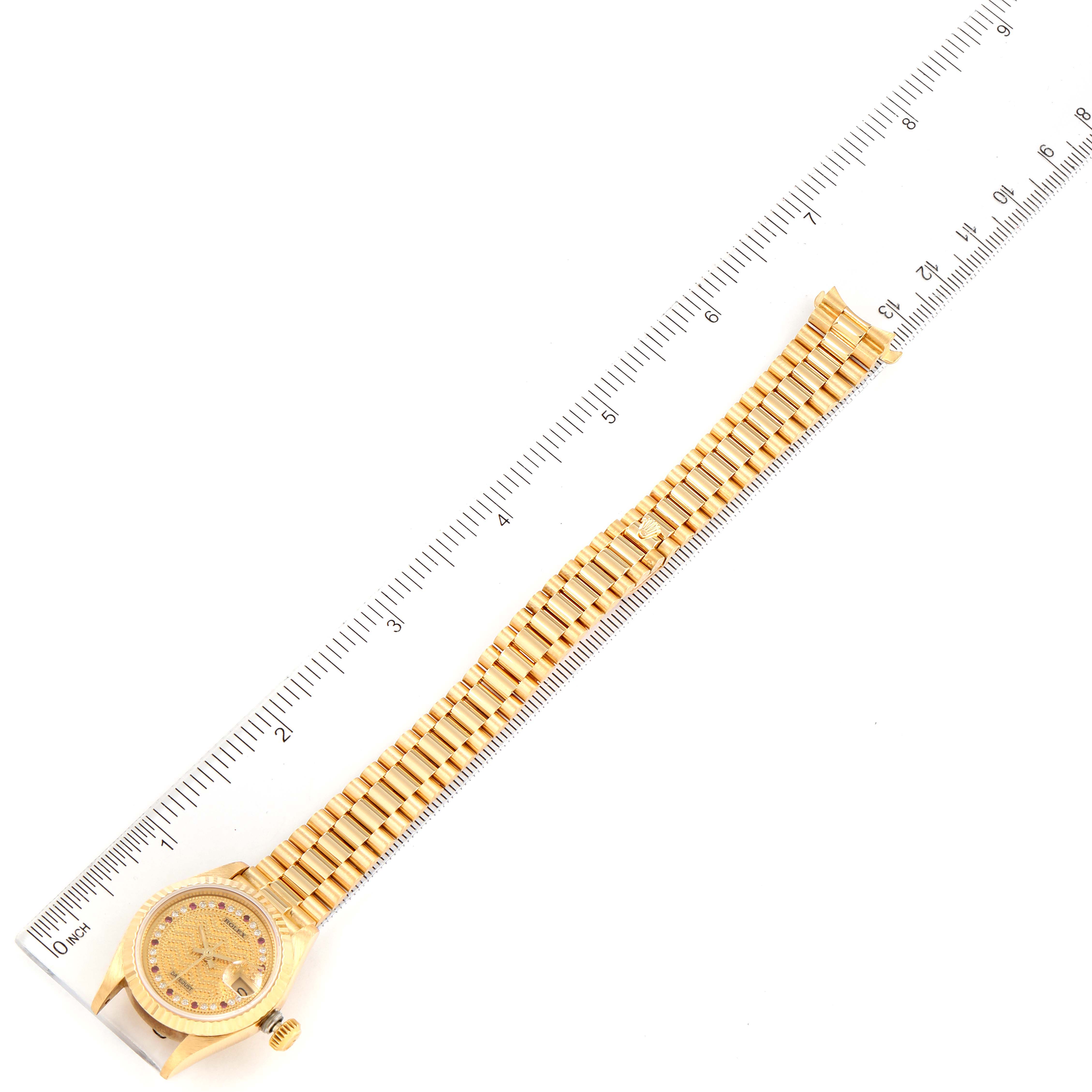 The image shows a top view of the Rolex President 69178 Women's Yellow Gold Champagne Dial 69178 Women's Yellow Gold Champagne Dial model watch, displaying the face and the entire watch band next to a ruler for scale.
