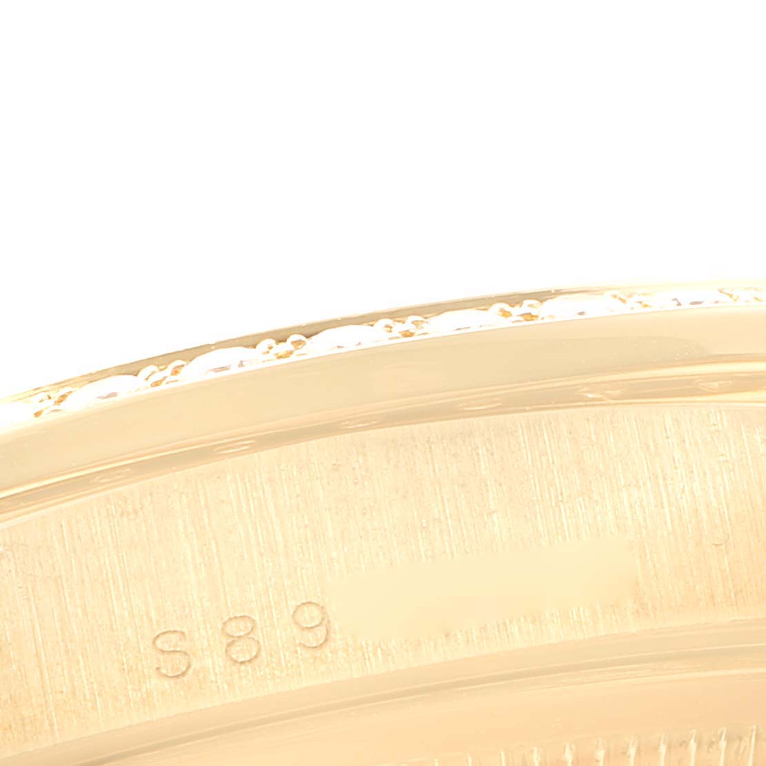 This image shows a close-up of the back case edge of a Rolex President 18348 Men's Yellow Gold Champagne Dial 18348 Men's Yellow Gold Champagne Dial model watch.