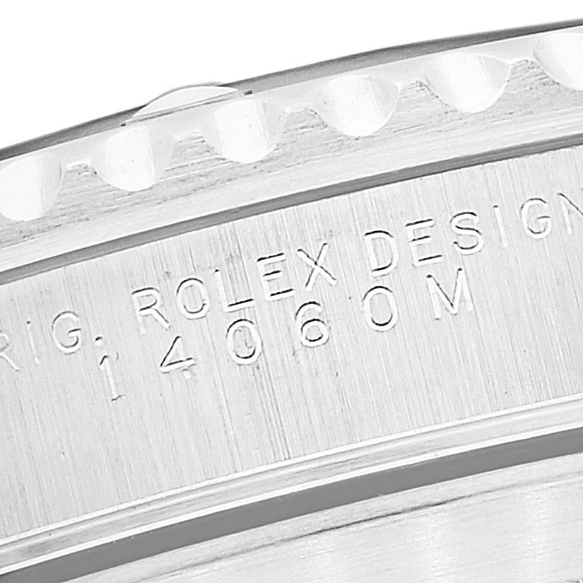 This is a close-up of the edge and engraved text on the case back of a Rolex Submariner 14060M Men
s Stainless Steel Black Dial 14060M Men
s Stainless Steel Black Dial watch.