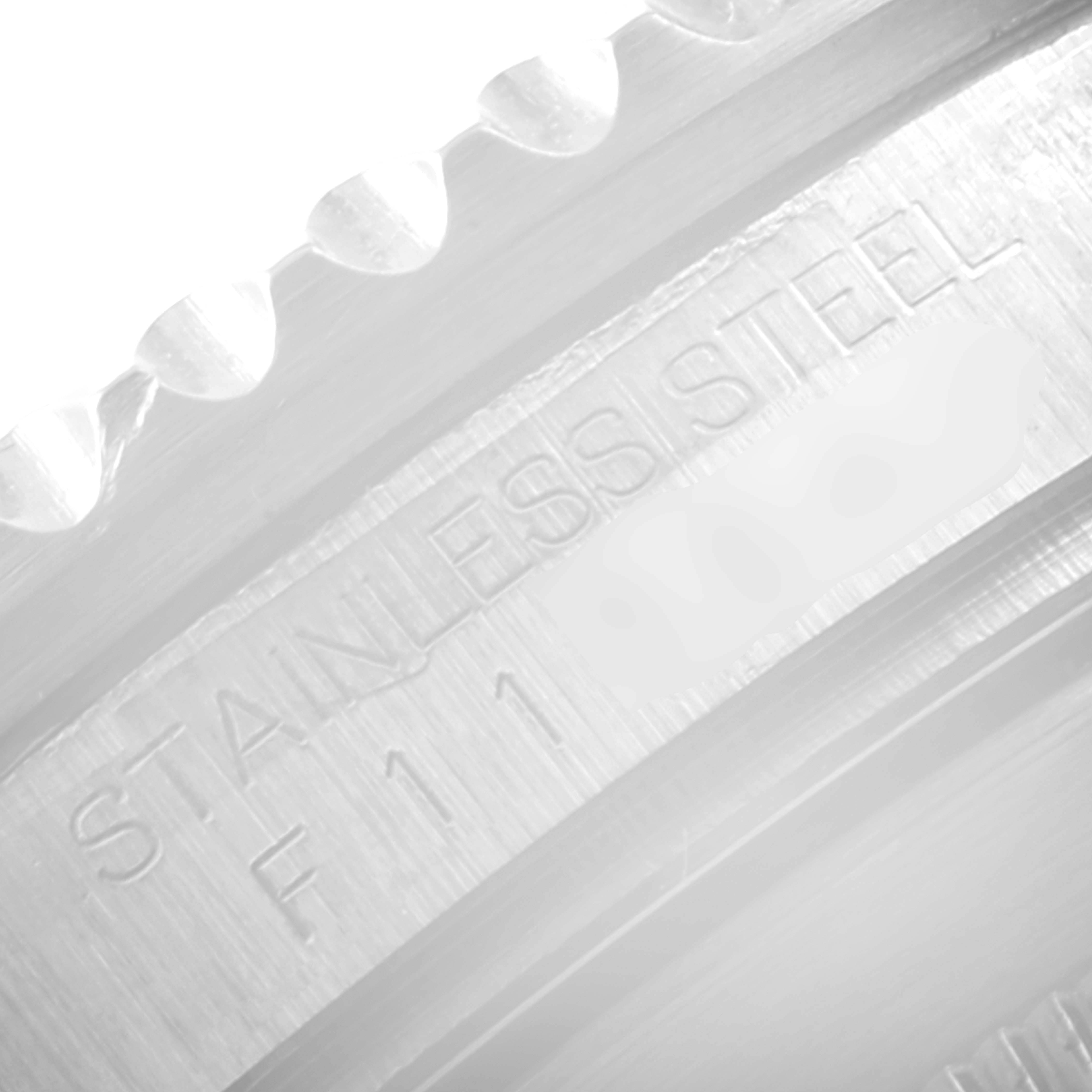 This image shows a close-up of the bezel and the "STAINLESS STEEL" engraving on a Rolex Submariner 16610 Men's Stainless Steel Black Dial 16610 Men's Stainless Steel Black Dial model watch.