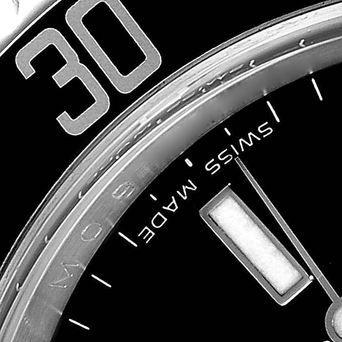 This close-up image of the Rolex Submariner 16610T Men's Stainless Steel Black Dial 16610T Men's Stainless Steel Black Dial watch shows the bezel, edge of the dial, hour marker, and minute hand.