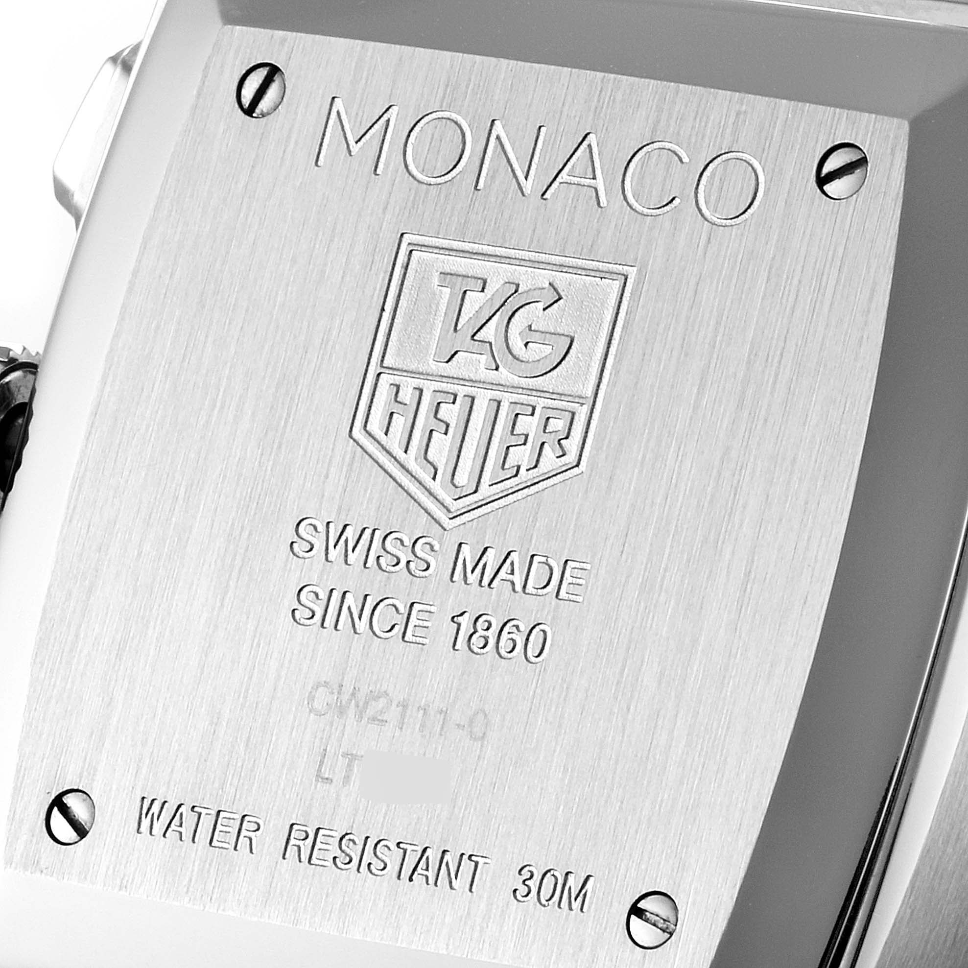 The image shows the back plate of the Tag Heuer Monaco CW2111 Men's Stainless Steel Black Dial CW2111 Men's Stainless Steel Black Dial watch, highlighting its engraving and water resistance details.