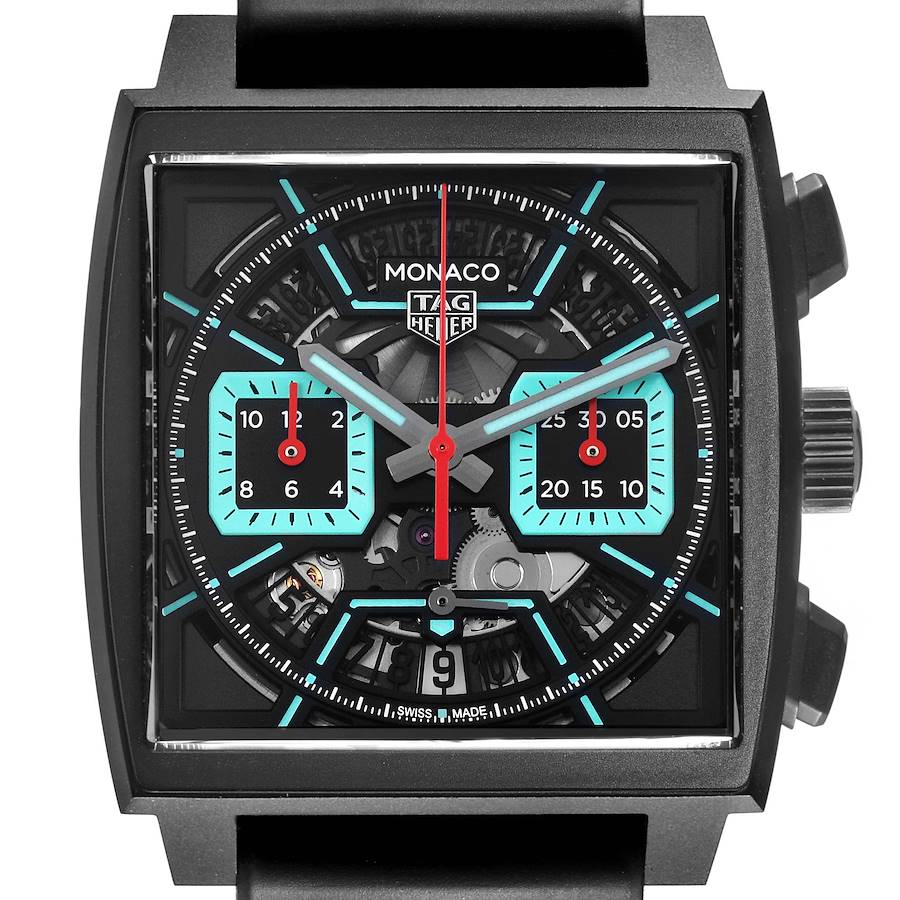 The Tag Heuer Monaco watch is shown from the front, highlighting the square face, sub-dials, and visible mechanics.