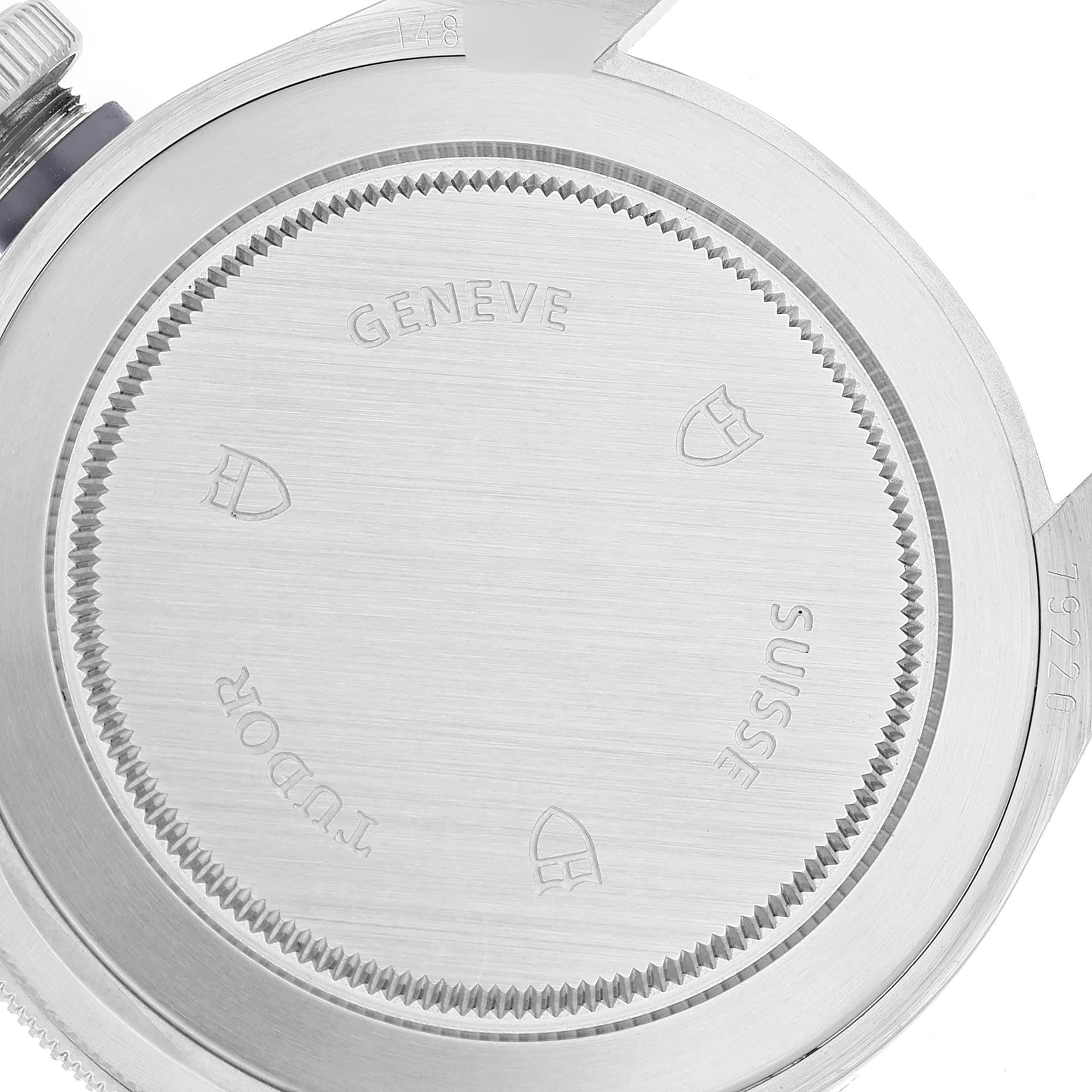 The image shows the case back of a Tudor Heritage Black Bay 79220 Men's Stainless Steel Black Dial 79220 Men's Stainless Steel Black Dial watch with engraving details.