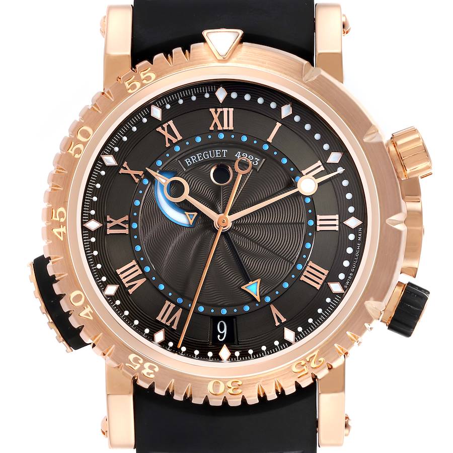 The Breguet Marine watch is shown from the front, highlighting the dial, bezel, and crown.