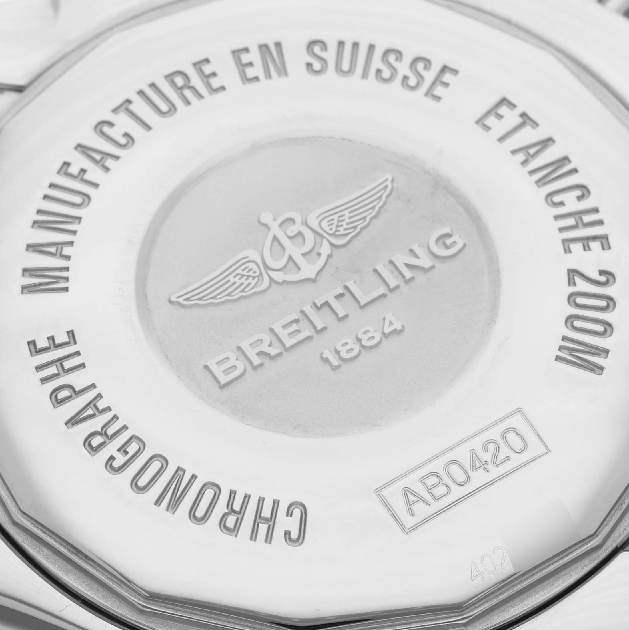 The image shows the back case of a Breitling Chronomat AB0420 Men's Stainless Steel Black Dial AB0420 Men's Stainless Steel Black Dial watch, highlighting brand details and model number engravings.