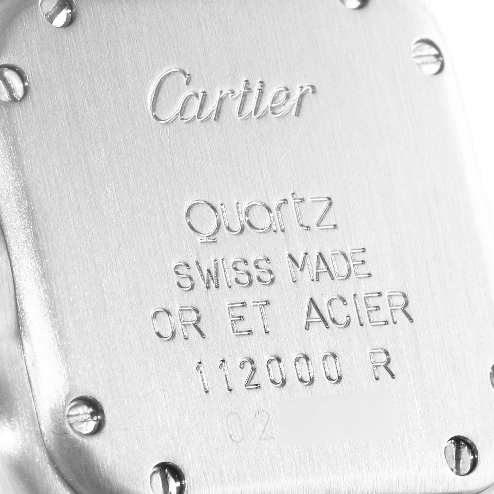 This close-up angle shows the back case of the Cartier Panthere W25029B6 Women
s Steel and Gold (two tone) Silver Dial W25029B6 Women
s Steel and Gold (two tone) Silver Dial watch with inscriptions detailing the model information.
