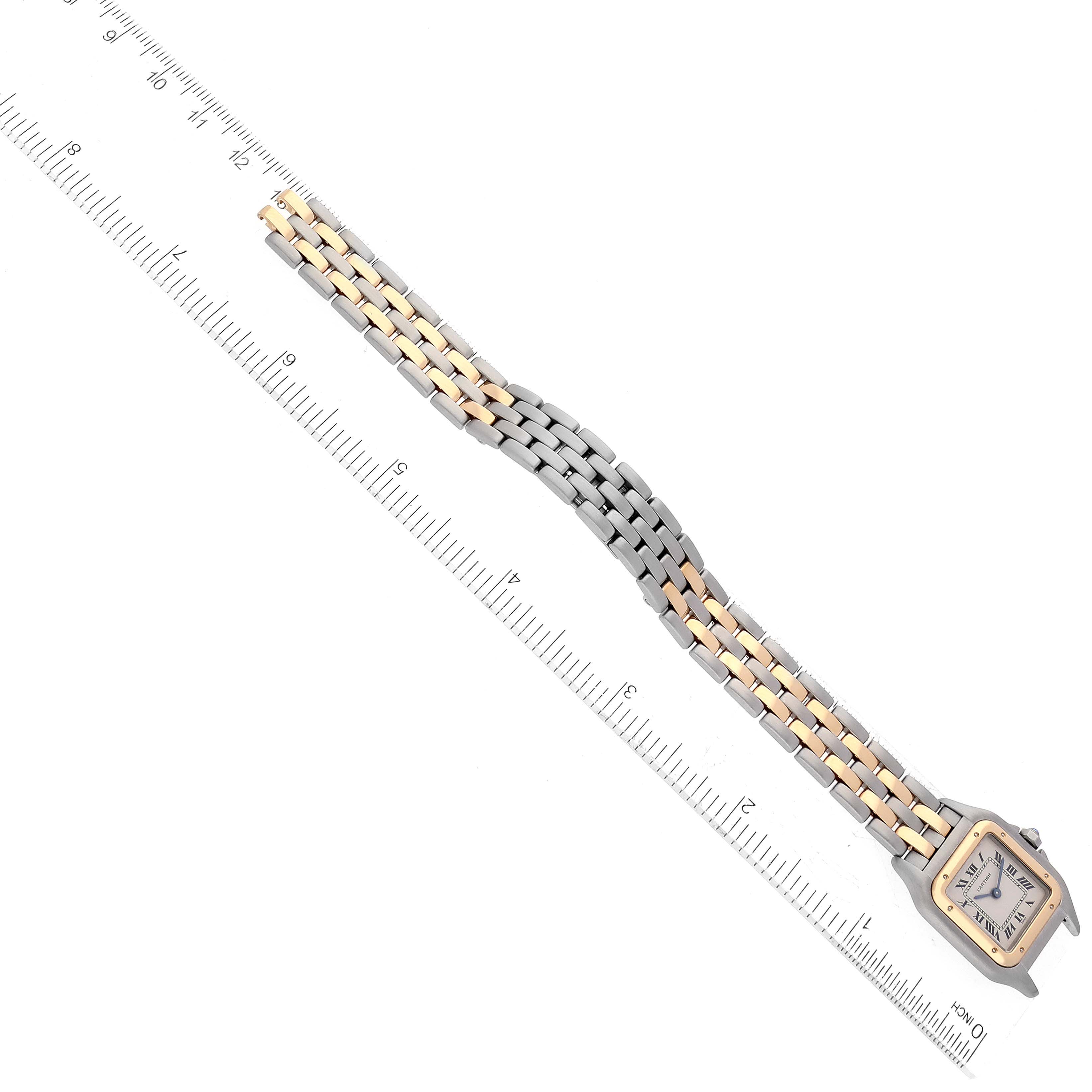 The image shows a Panthere model by Cartier laid flat next to a ruler, highlighting the bracelet and face from an overhead perspective.
