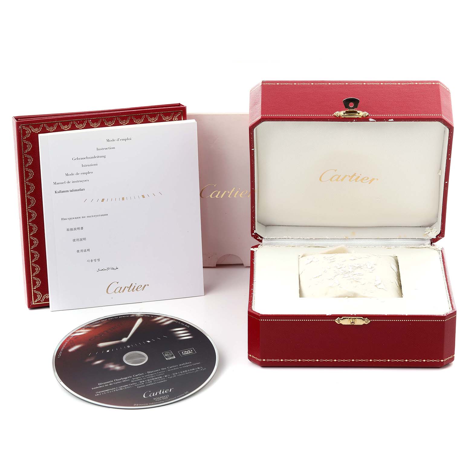 The image shows the Cartier Santos W20072X7 Men's Steel and Gold (two tone) Silver Dial W20072X7 Men's Steel and Gold (two tone) Silver Dial watch box, instruction booklet, and a DVD from an overhead angle.