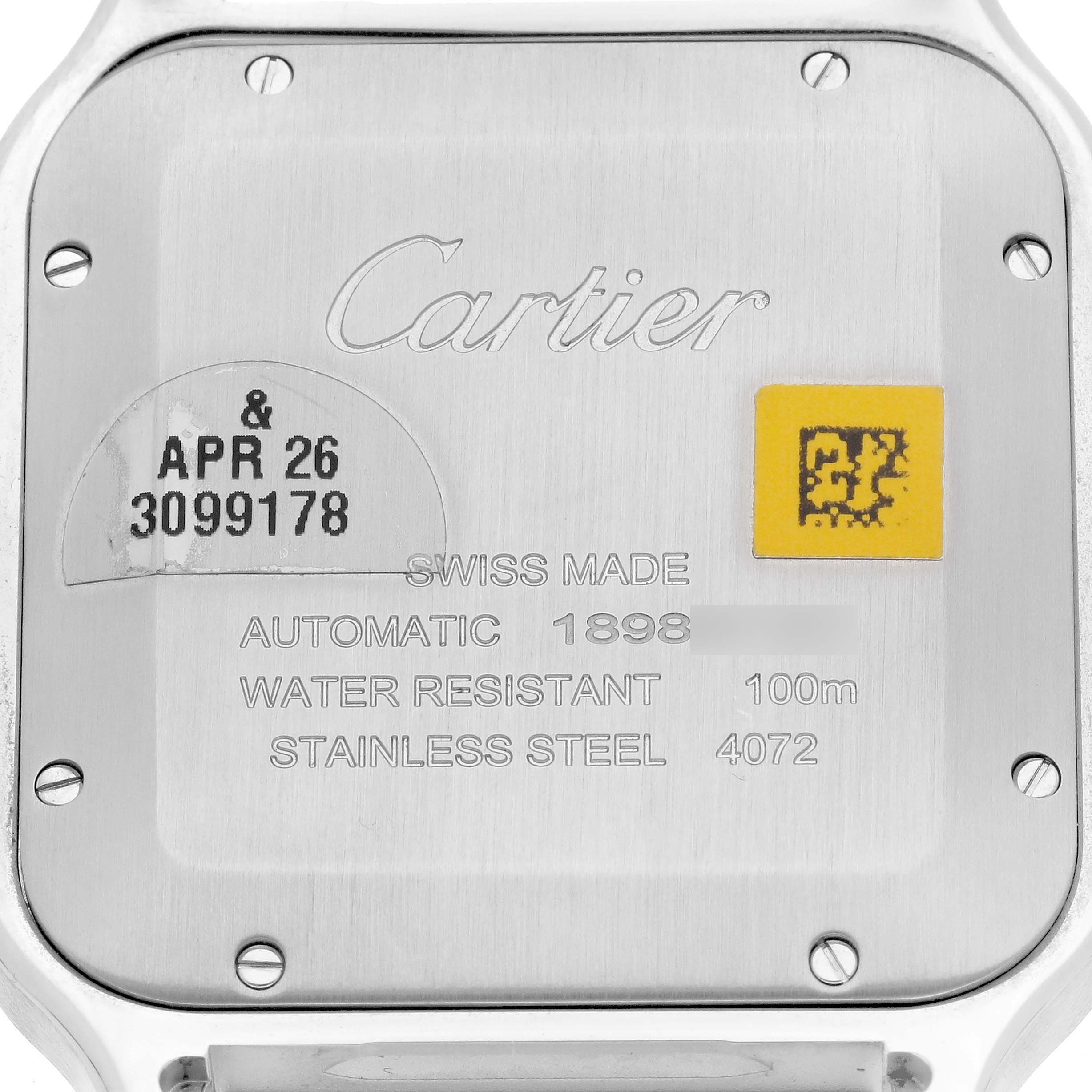 The image shows the back of a Cartier Santos WSSA0018 Men's Stainless Steel Silver Dial WSSA0018 Men's Stainless Steel Silver Dial watch, highlighting its engraved details and specifications.